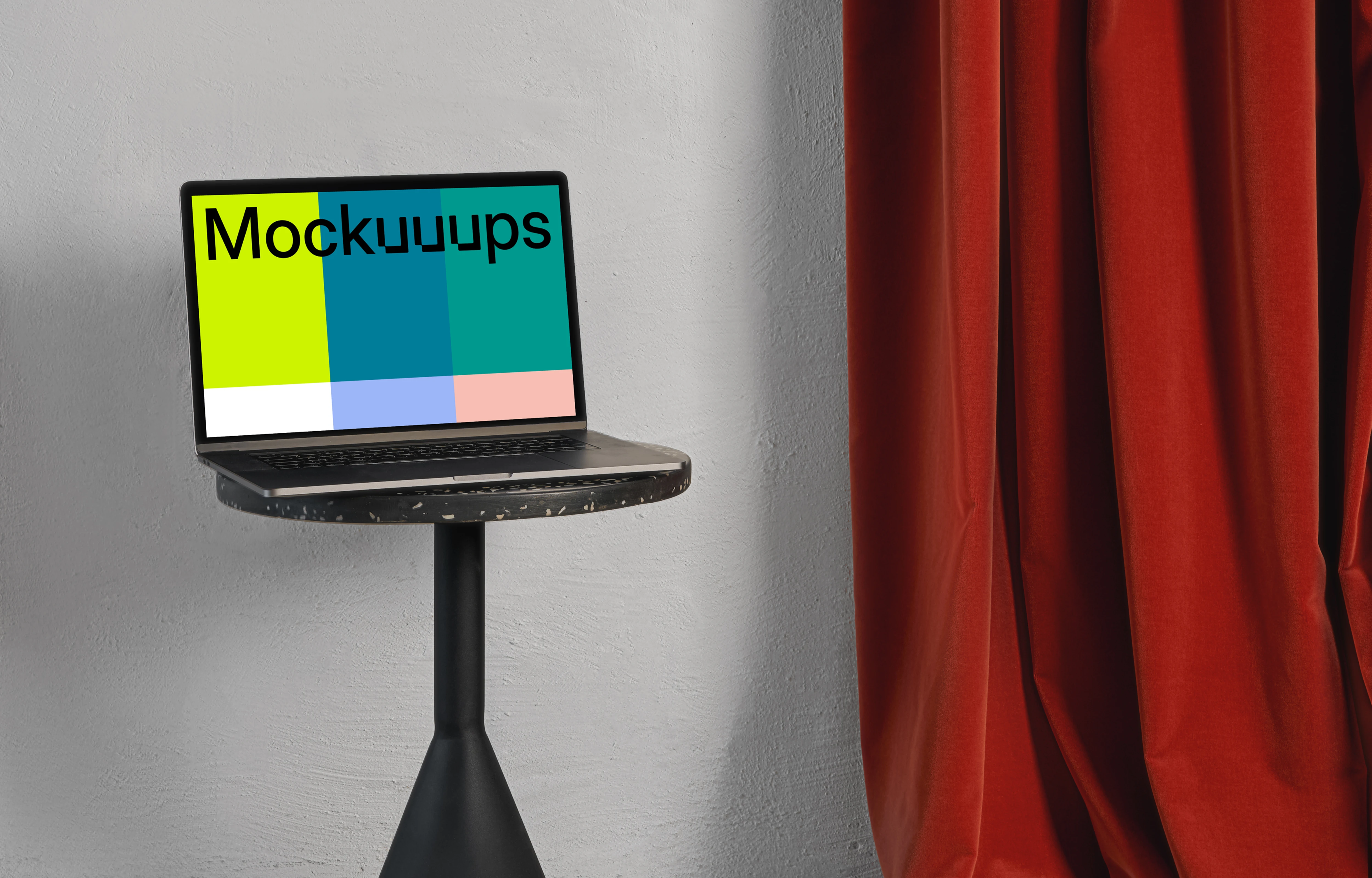 MacBook mockup on a black stool with red curtain in the background
