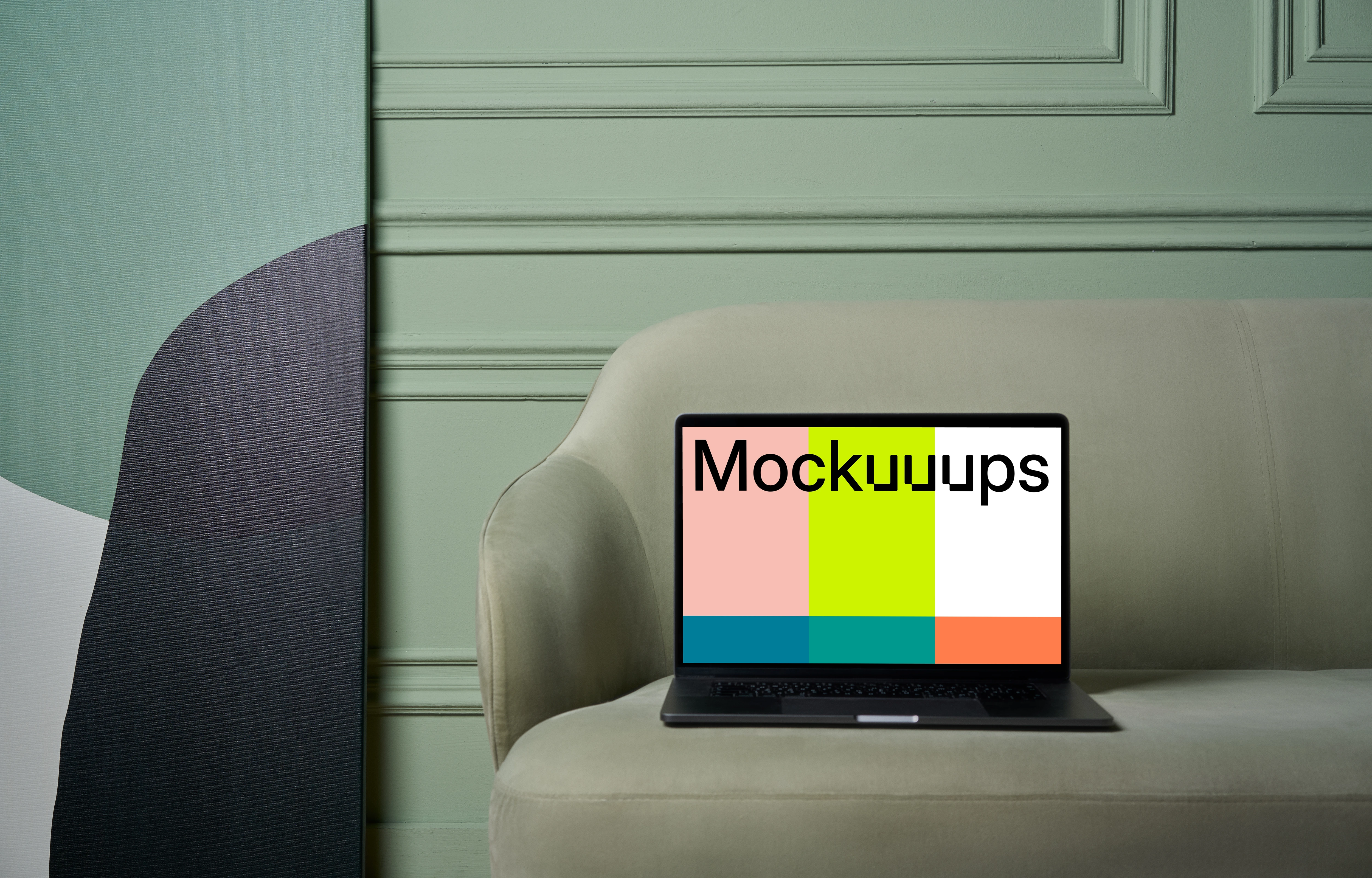 MacBook mockup on a couch with beside painting