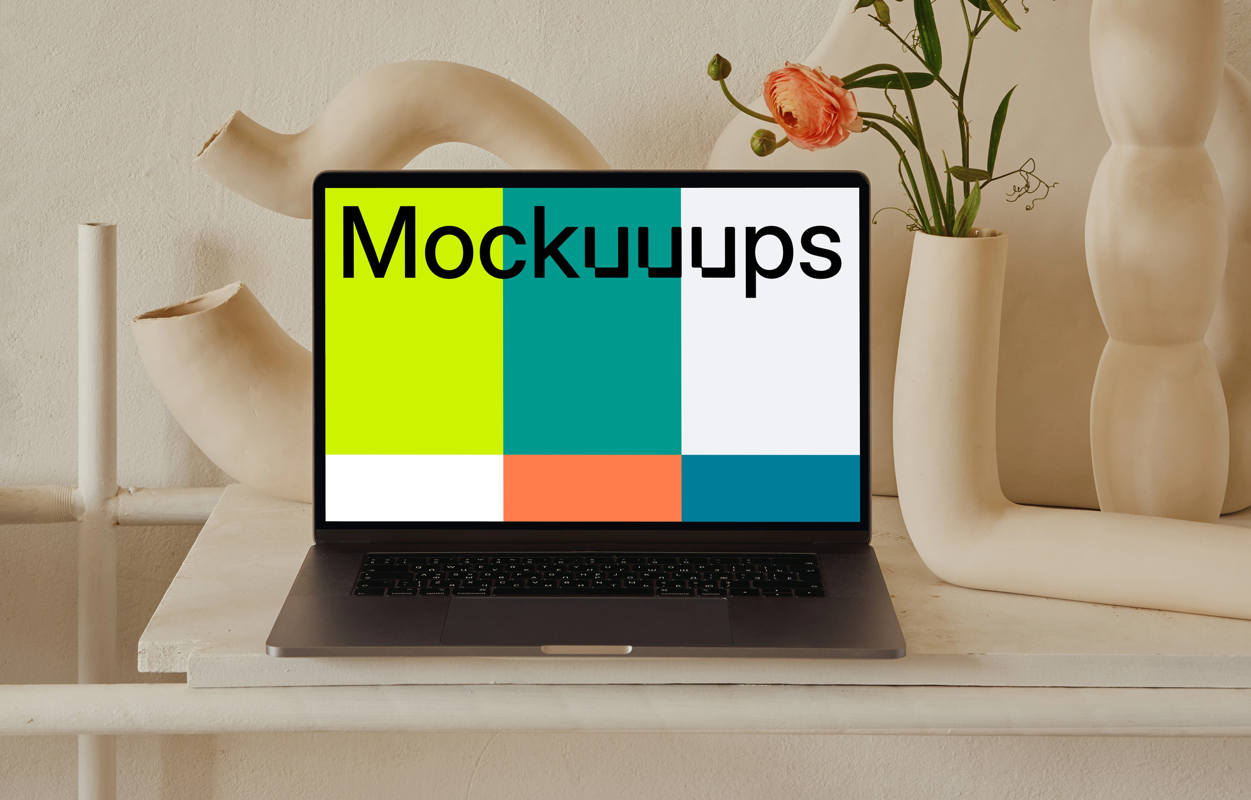 MacBook mockup on a peach colored table with a fancy flower vase