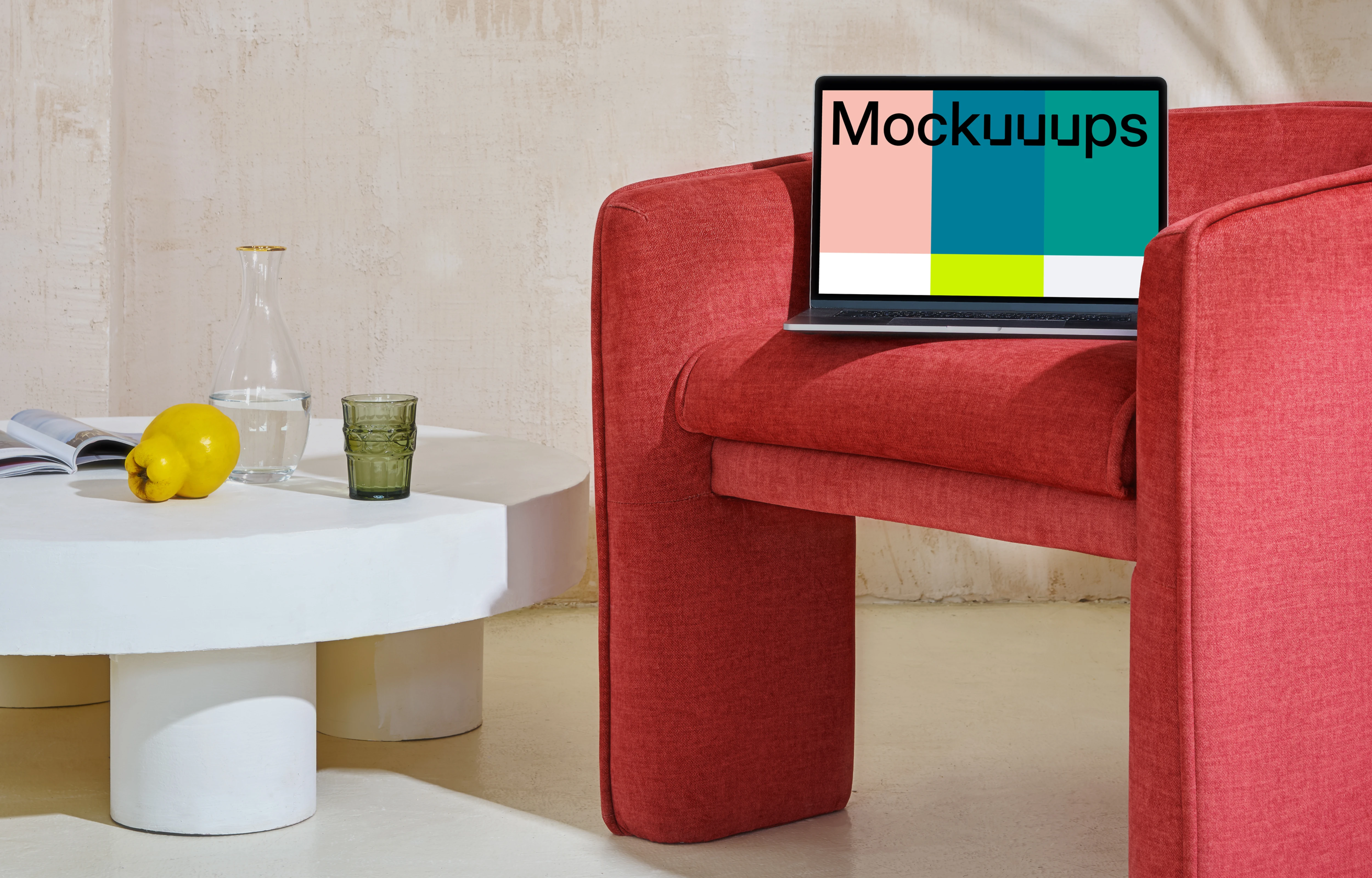 MacBook mockup on a red couch with a center table close by