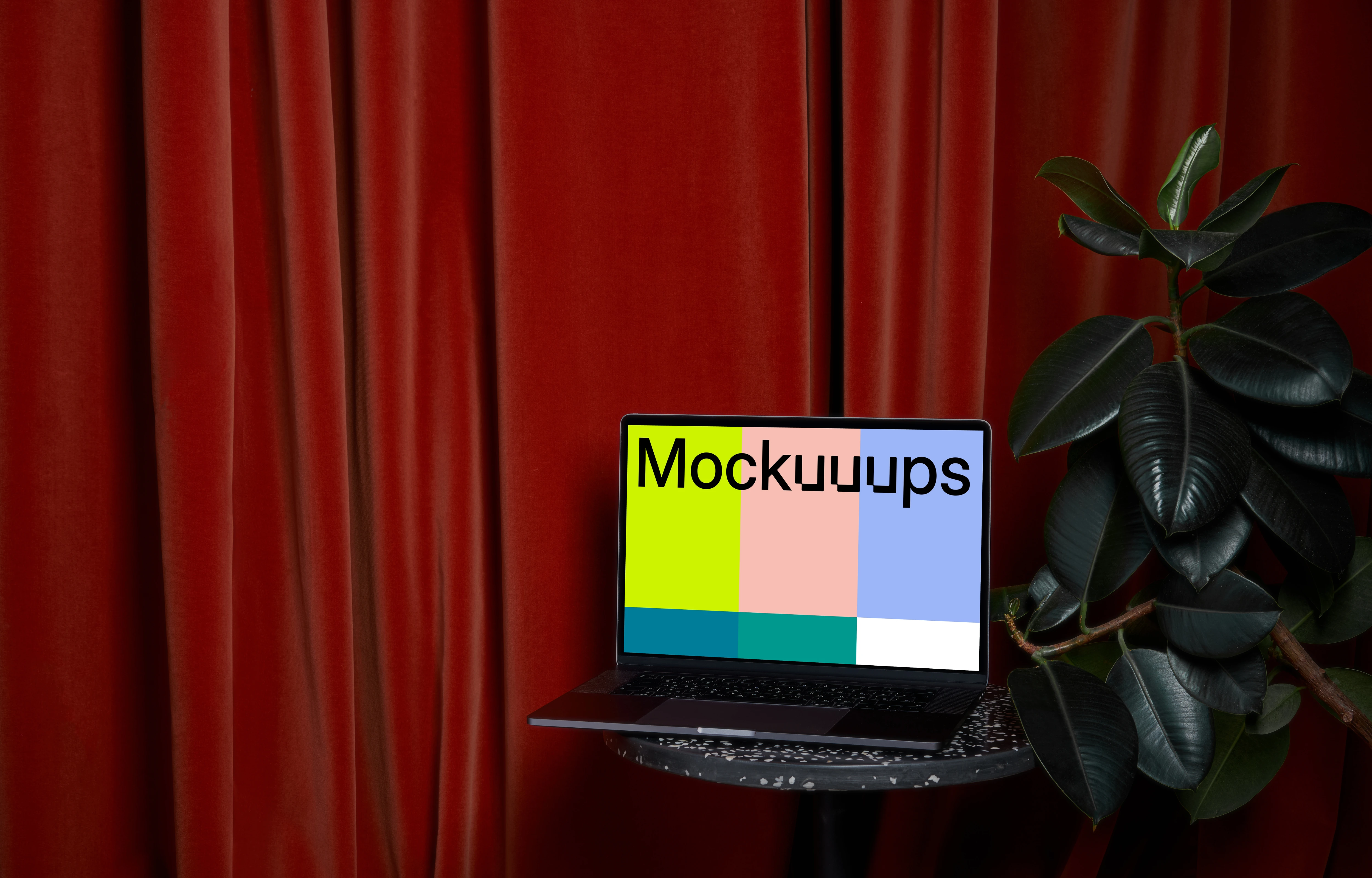 MacBook mockup on a stool beside flower pot