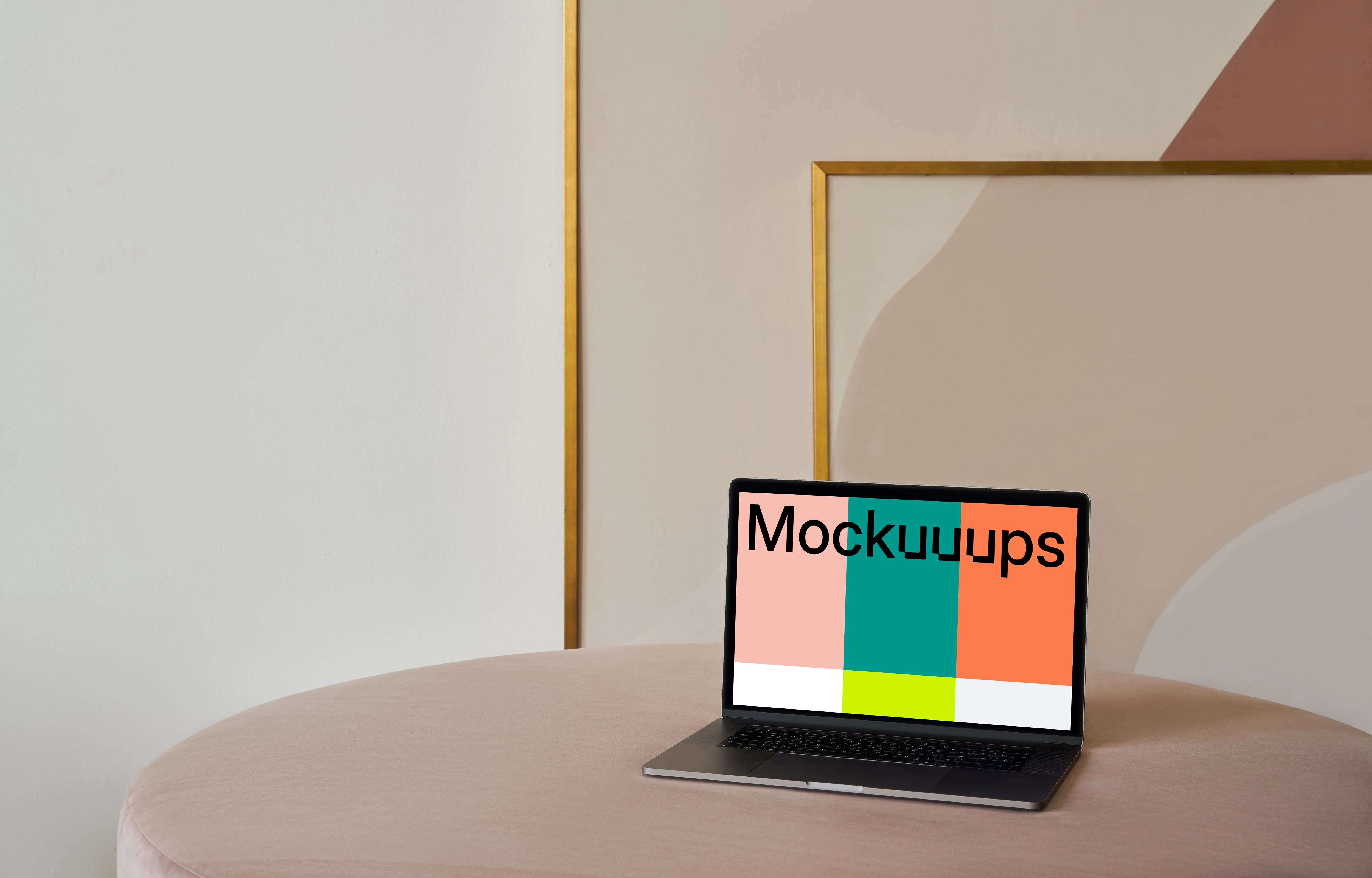 MacBook mockup on a table with a beautiful painting behind it
