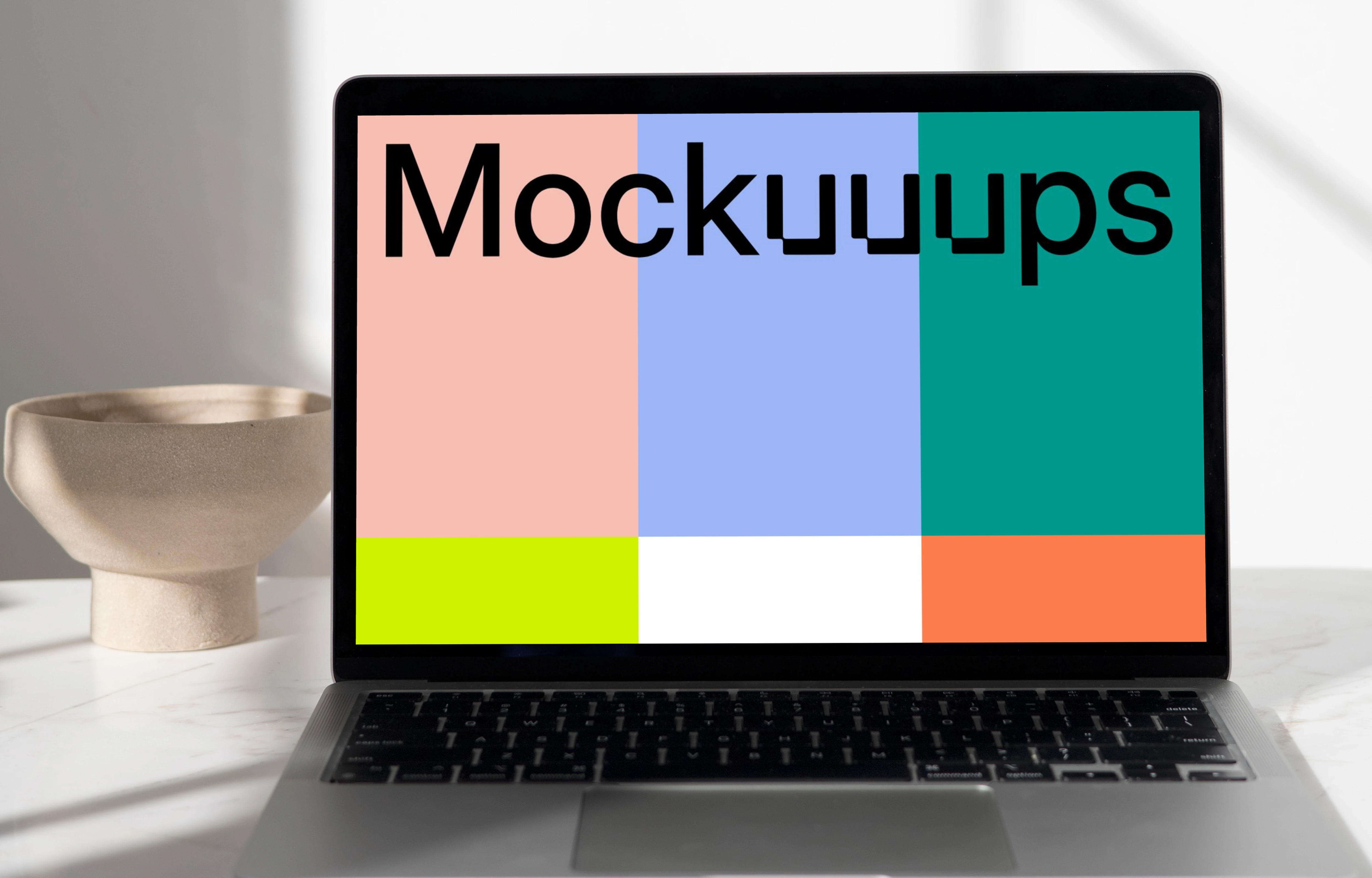 MacBook mockup on a table with ceramic bowl in the background