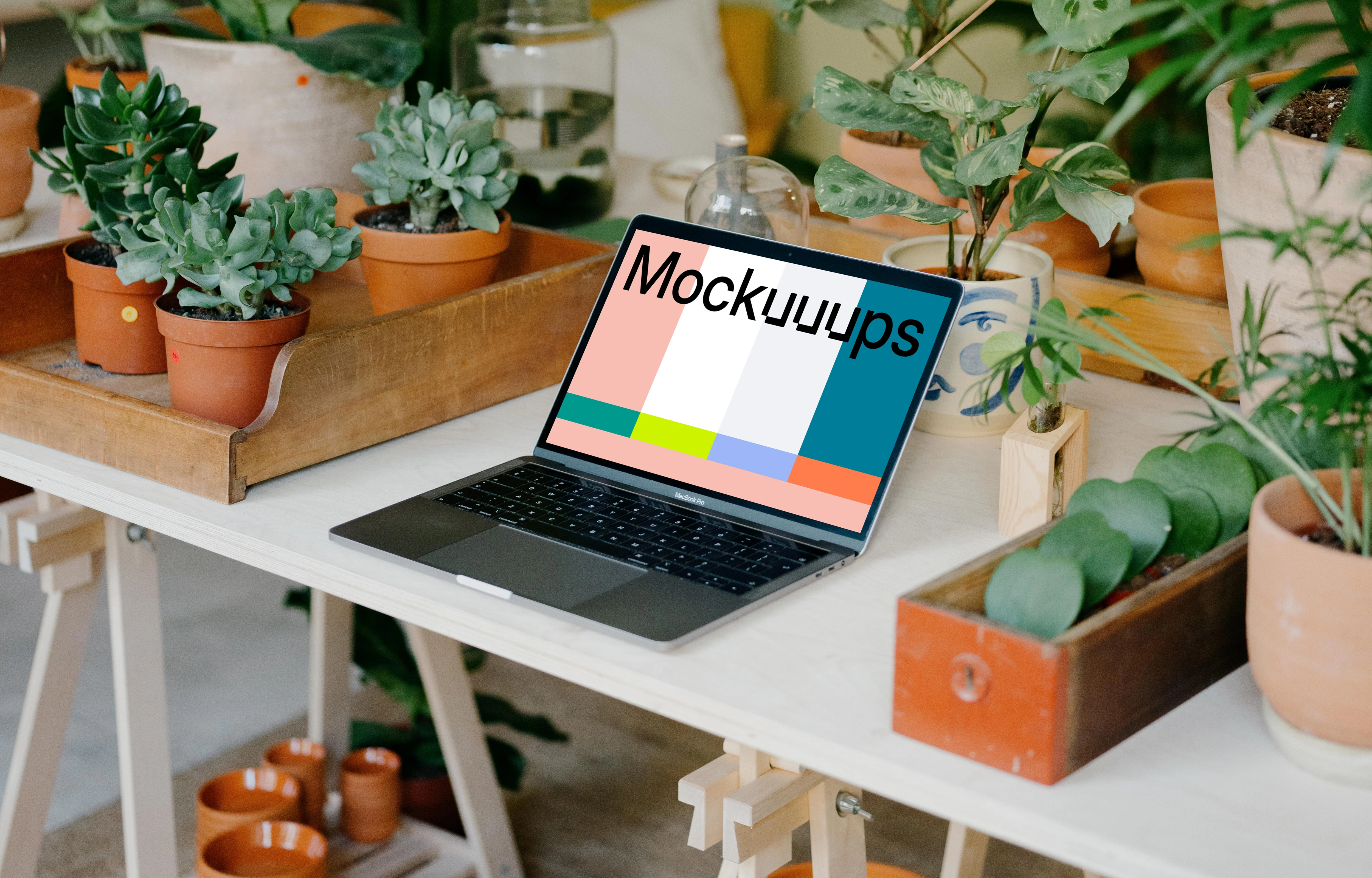 MacBook Pro Mockup between potted plants