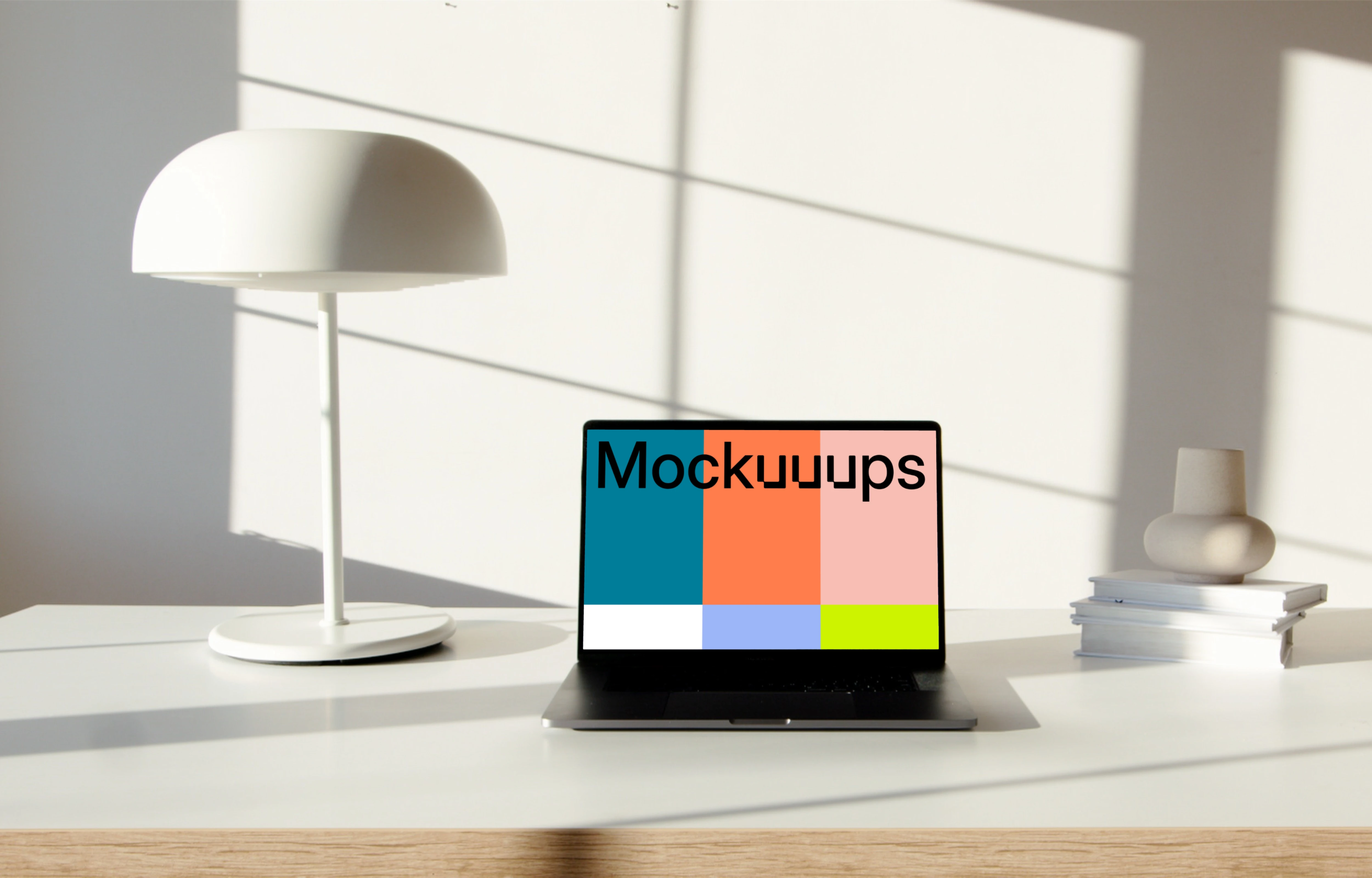 MacBook Pro mockup on a table beside a bright bulb