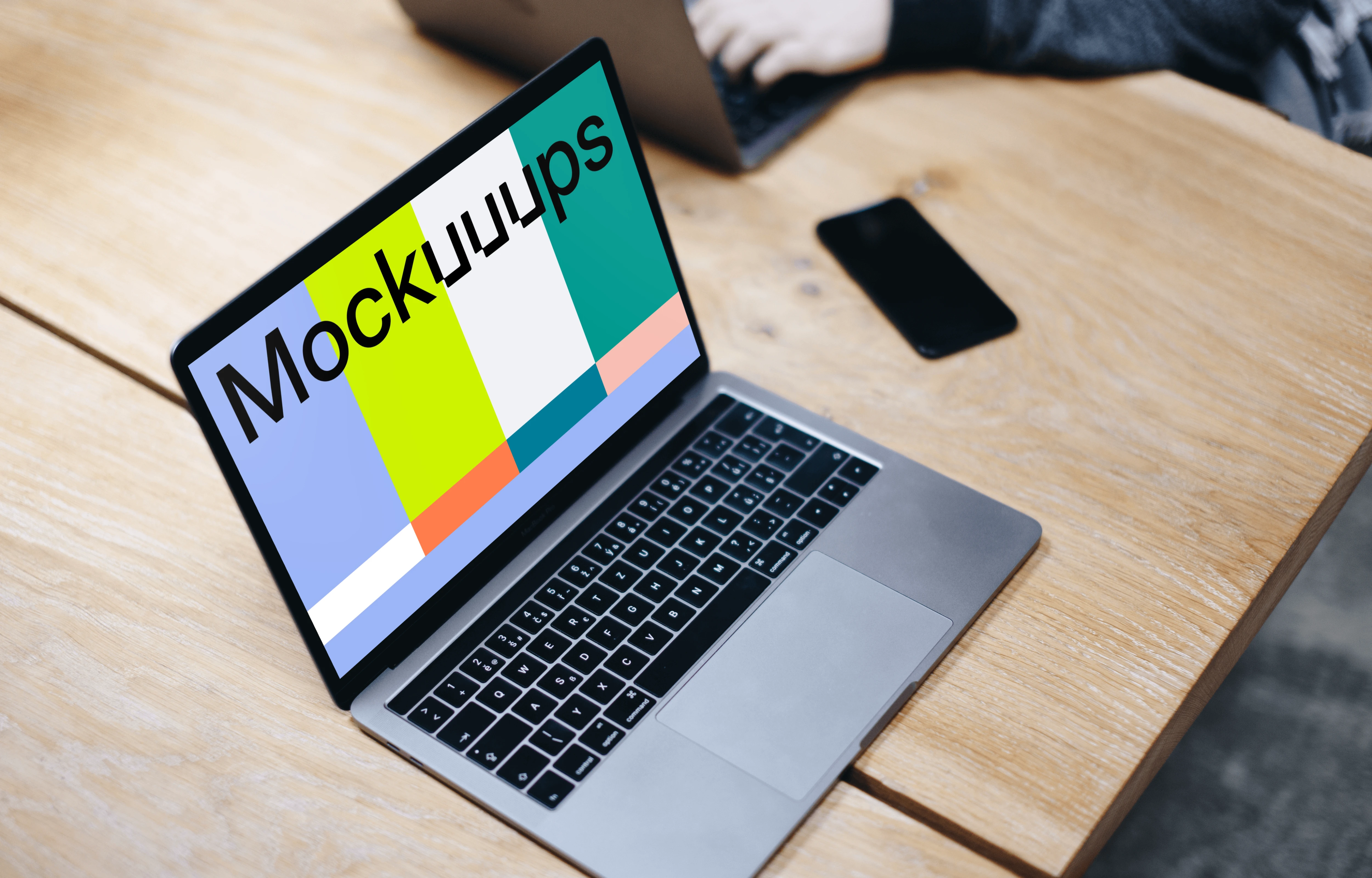 Free Macbook Pro Space Gray mockup on the wooden table