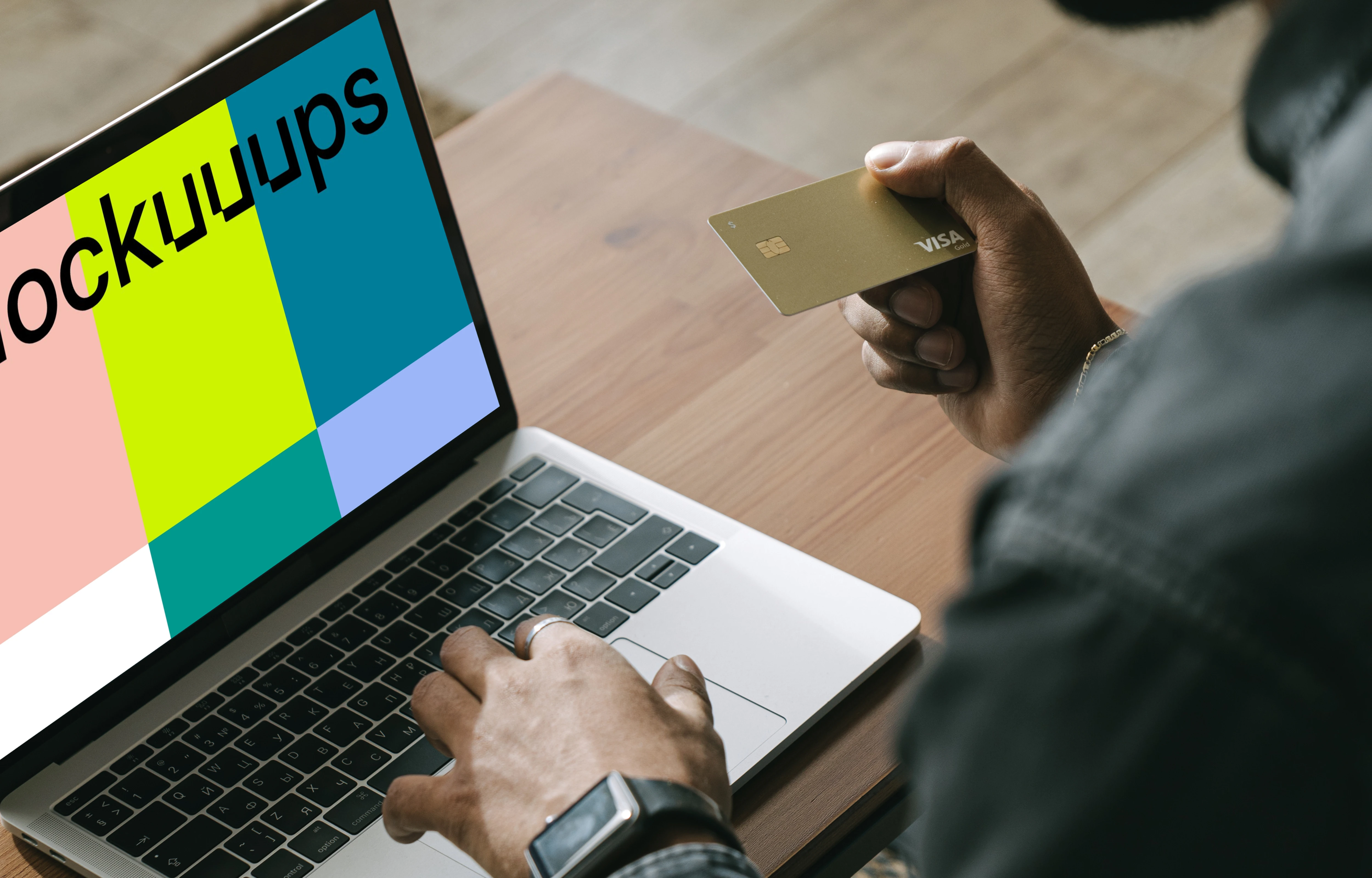 Man making online payment with a Visa card on his MacBook computer mockup.