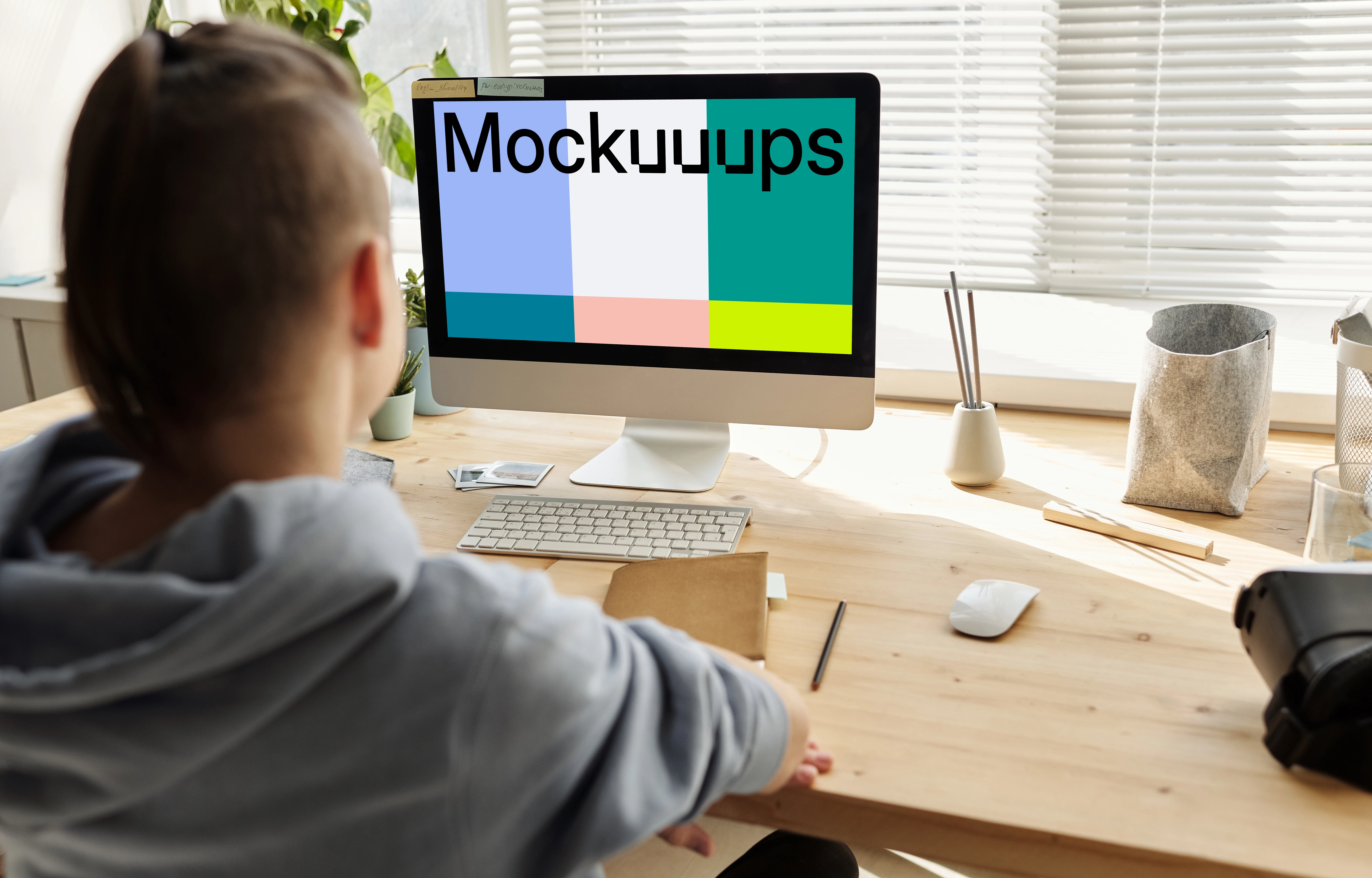 Mockup of a young girl using an iMac close to a window
