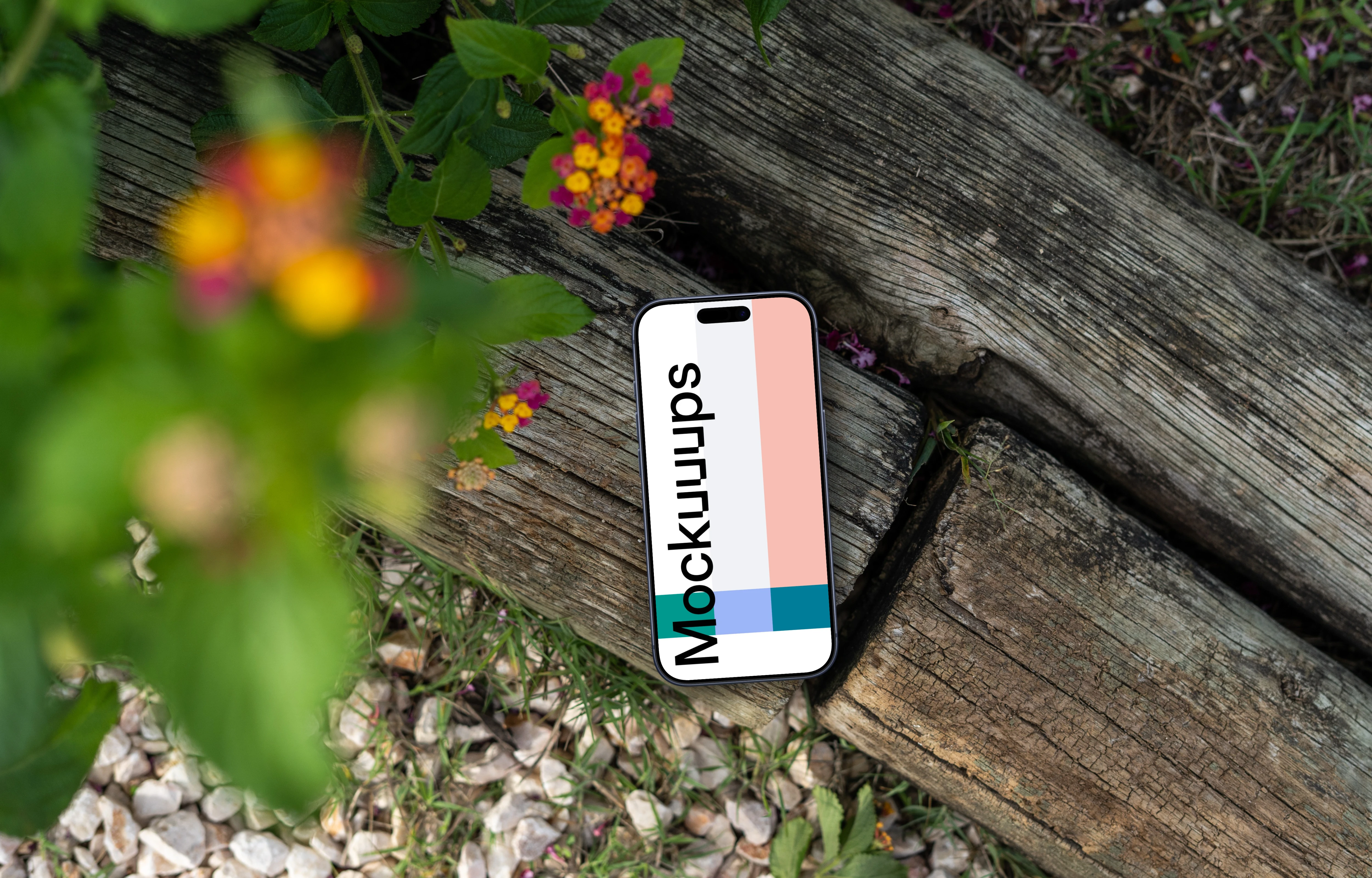 Smartphone mockup laying on wood in a garden