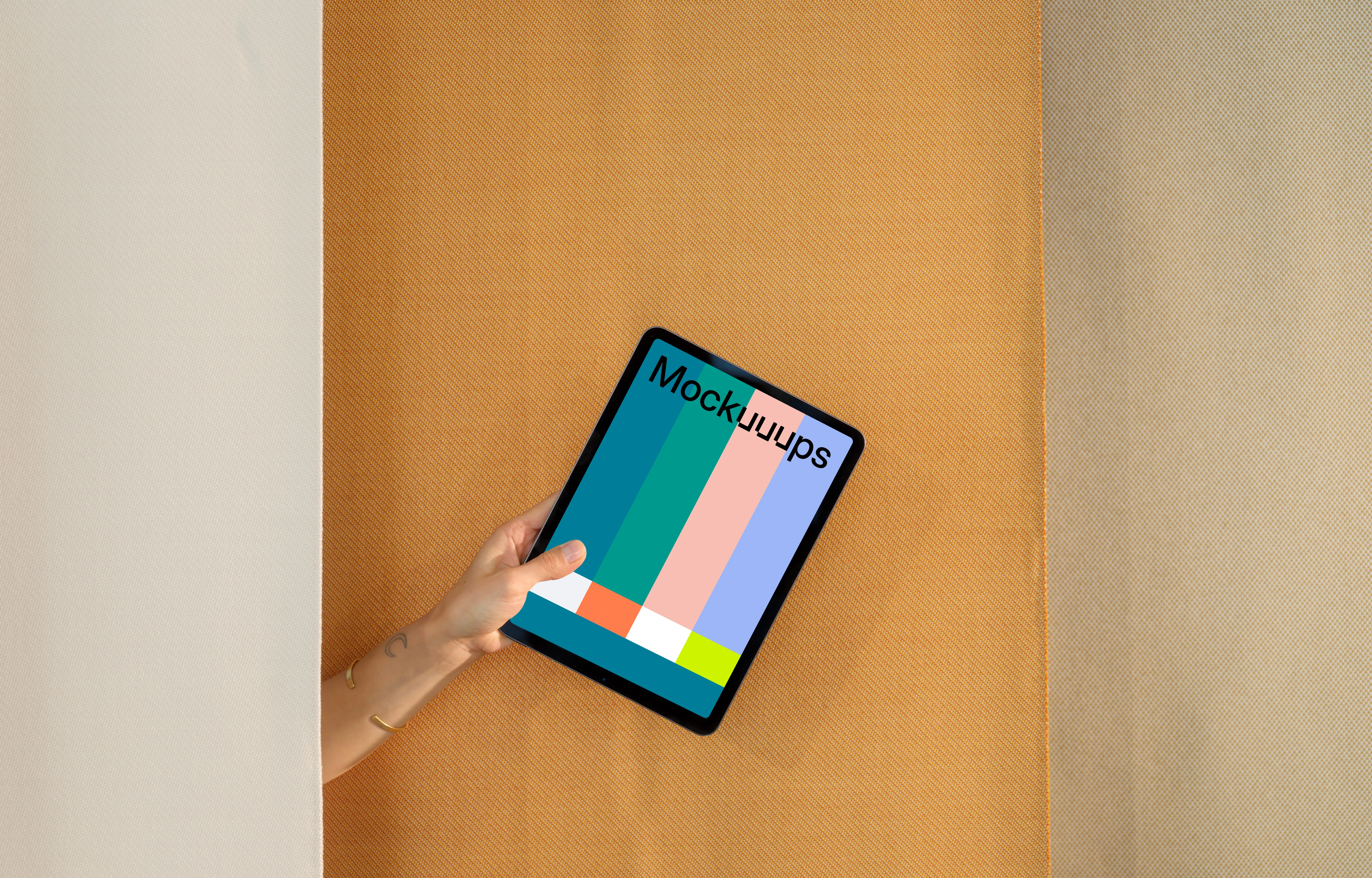 iPad Air mockup with a person holding it against a dual-tone backdrop