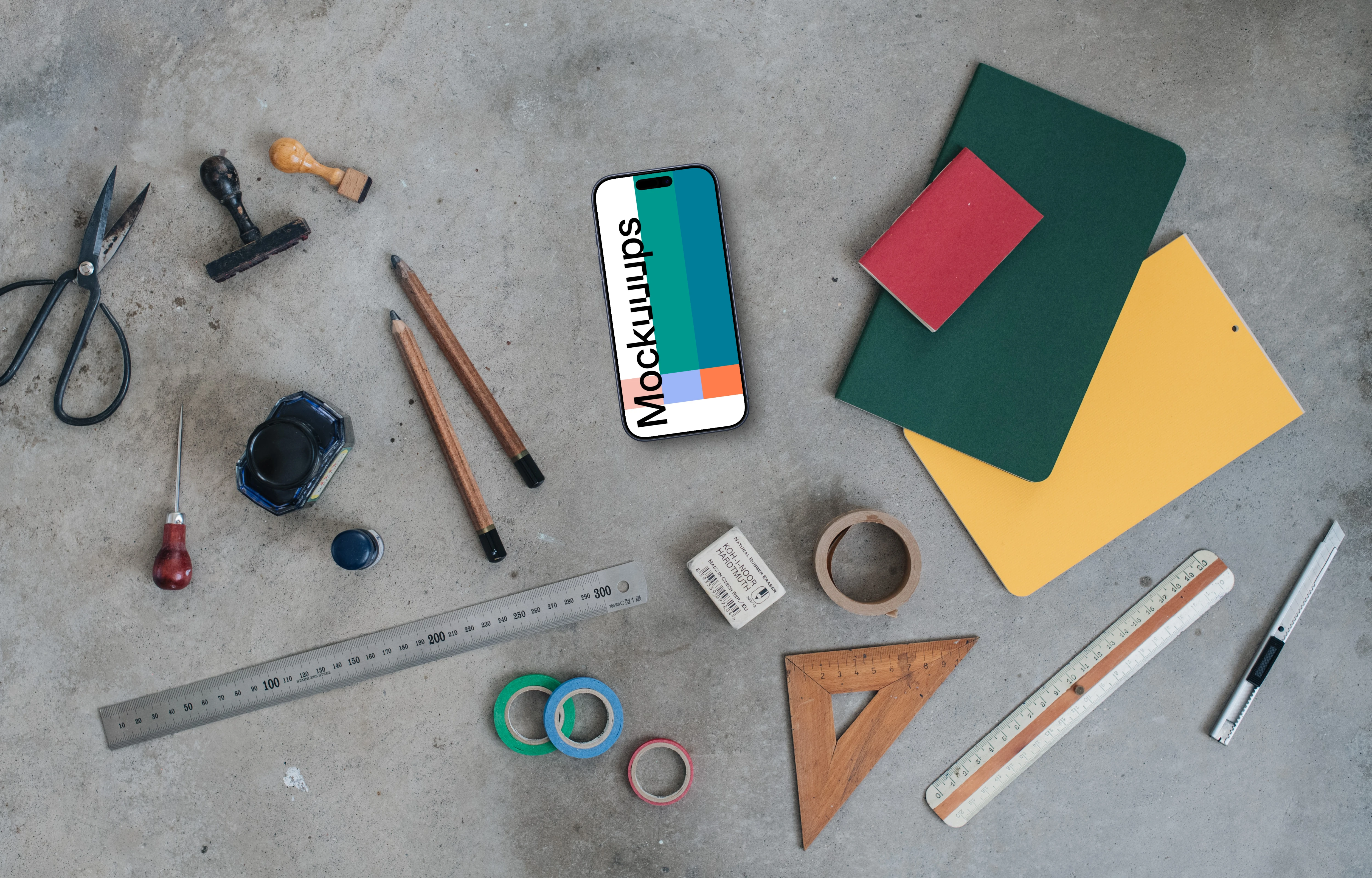 Smartphone mockup next to the colorful notebooks