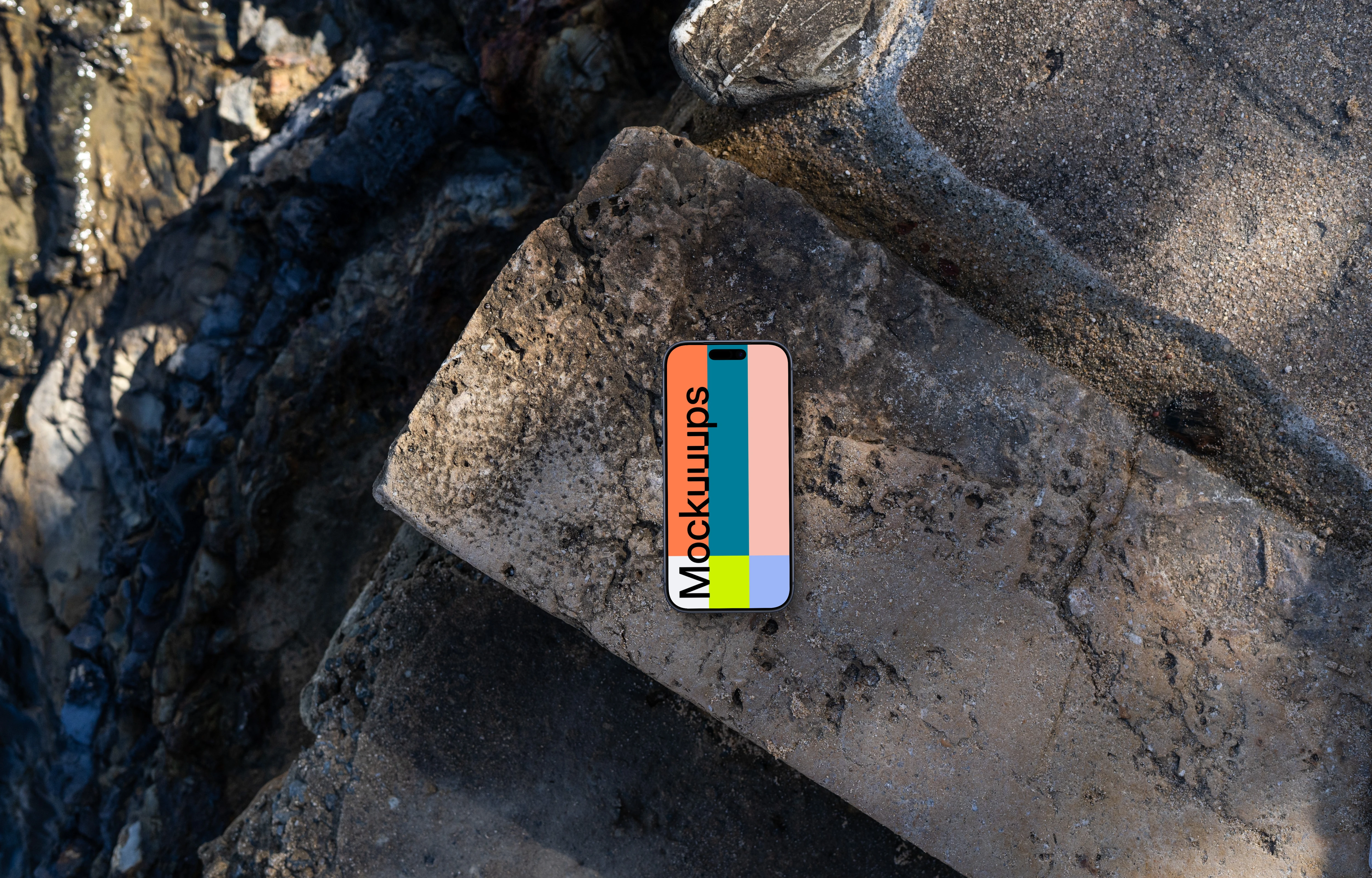 Smartphone mockup on a rocky surface