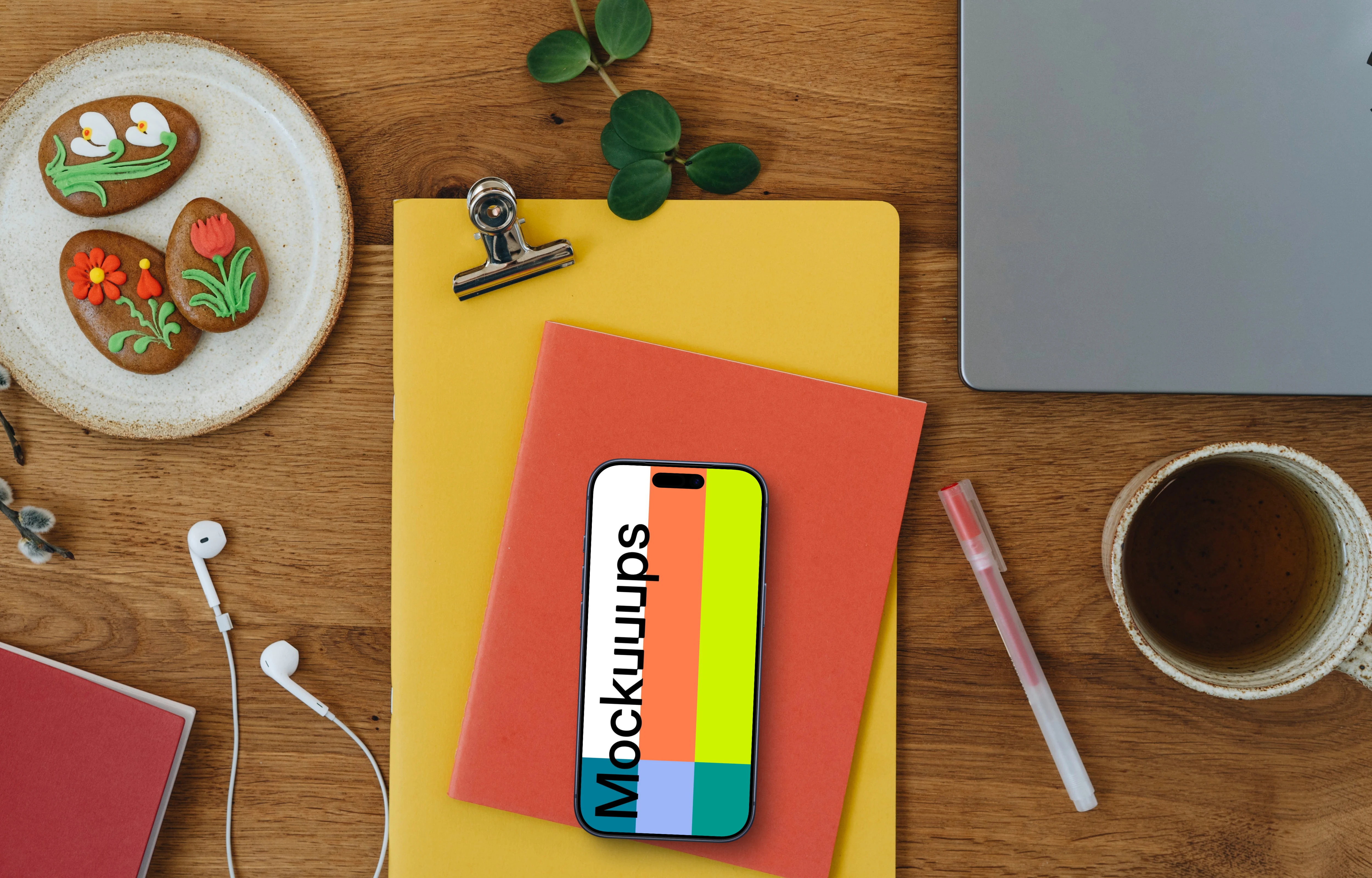 Smartphone mockup on colorful notebooks with Easter gingerbreads