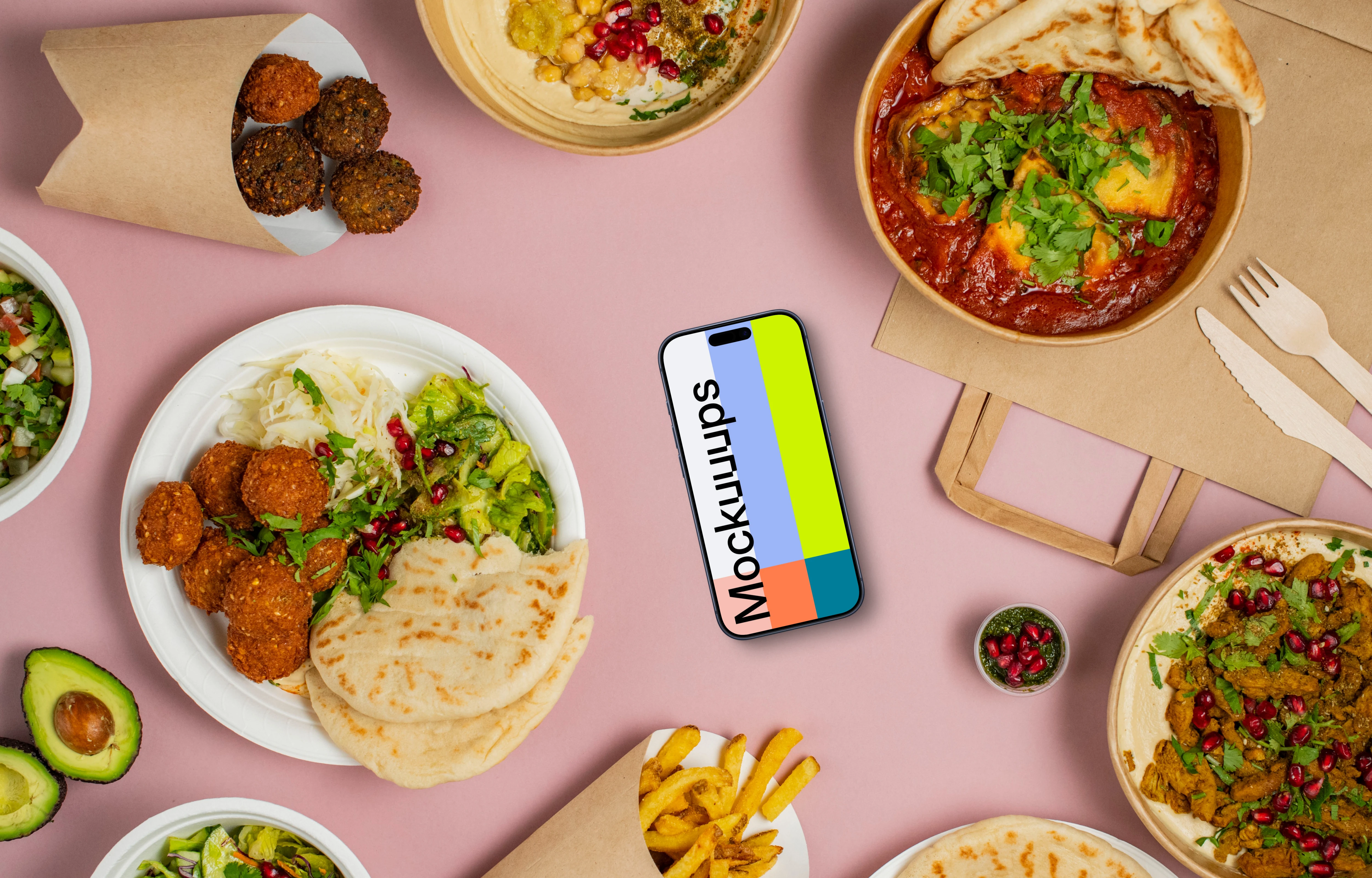 Smartphone mockup surrounded by selection of delicious Middle Eastern dishes