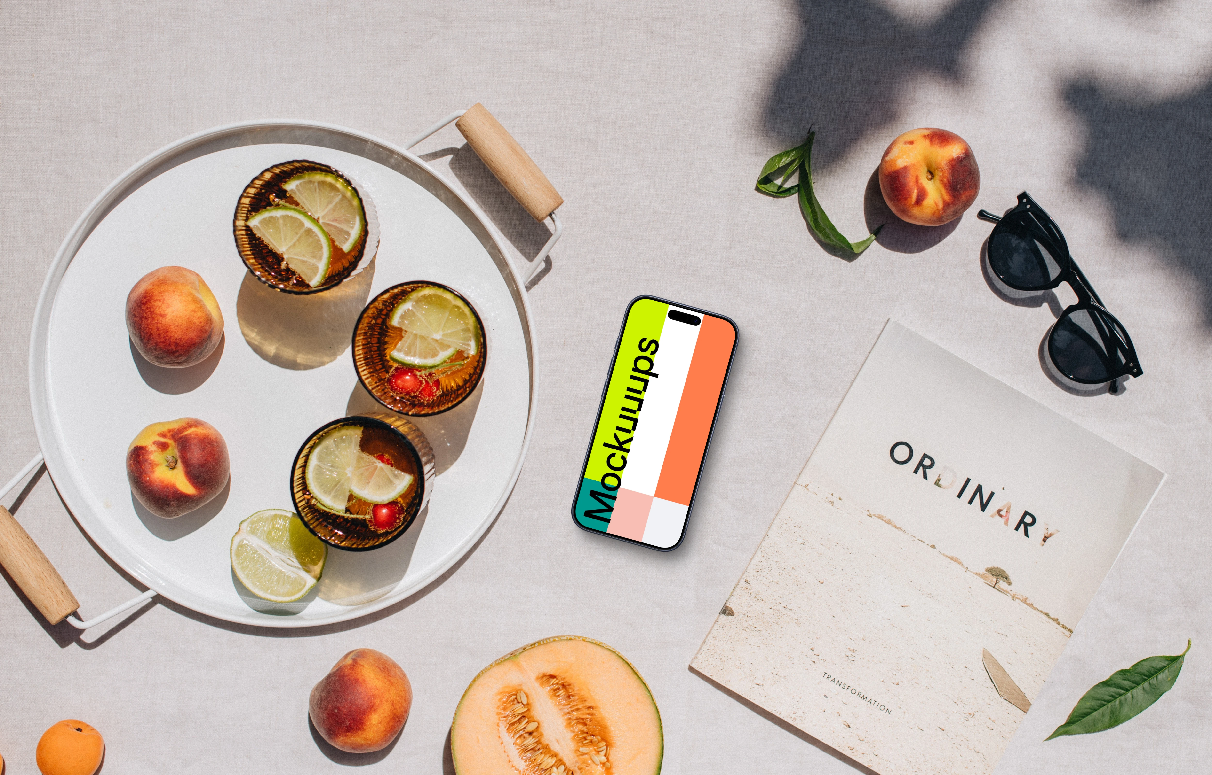 Top view of phone mockup next to the magazine and fresh fruit