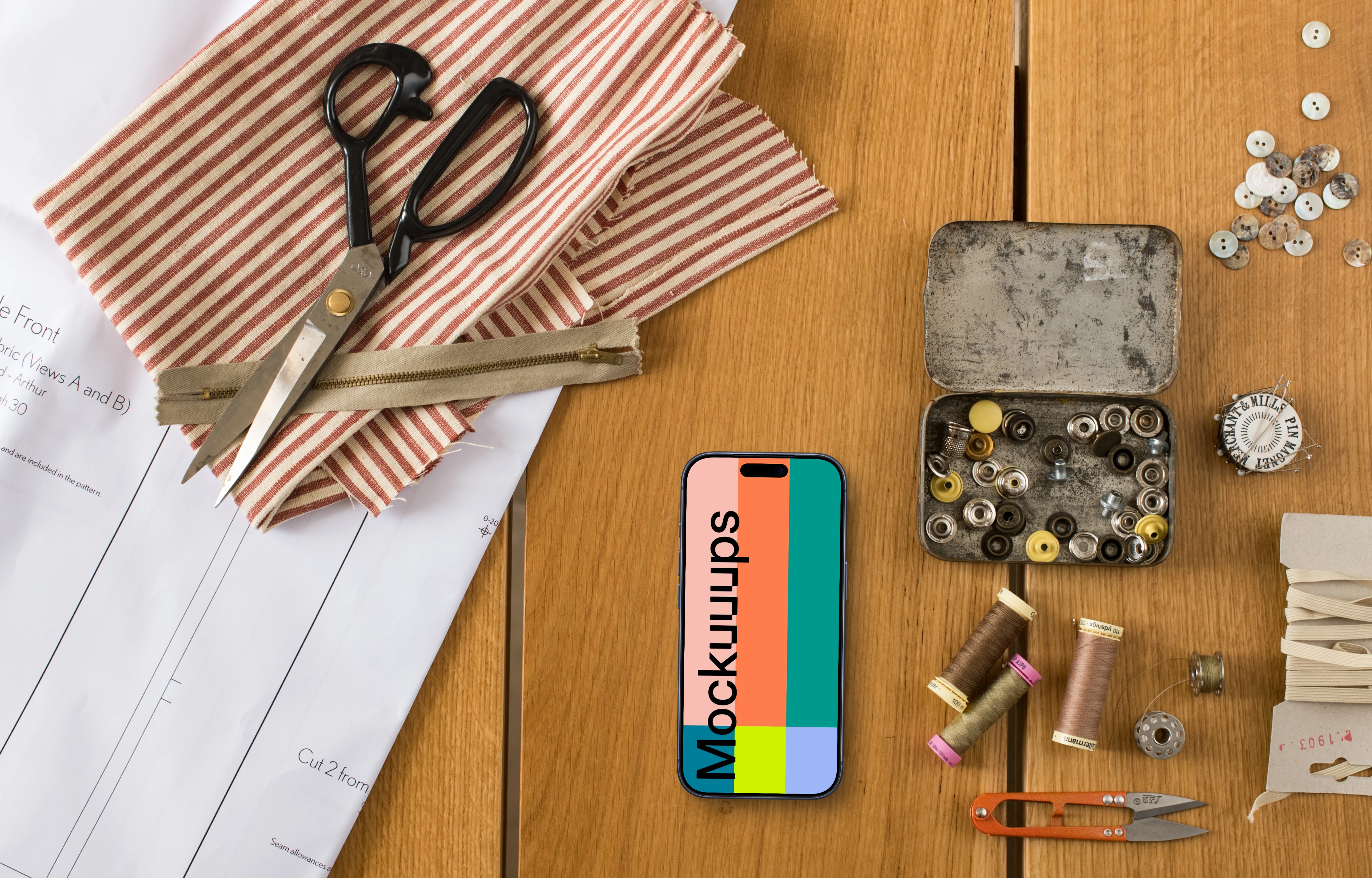 Top view of phone mockup with sewing accessories