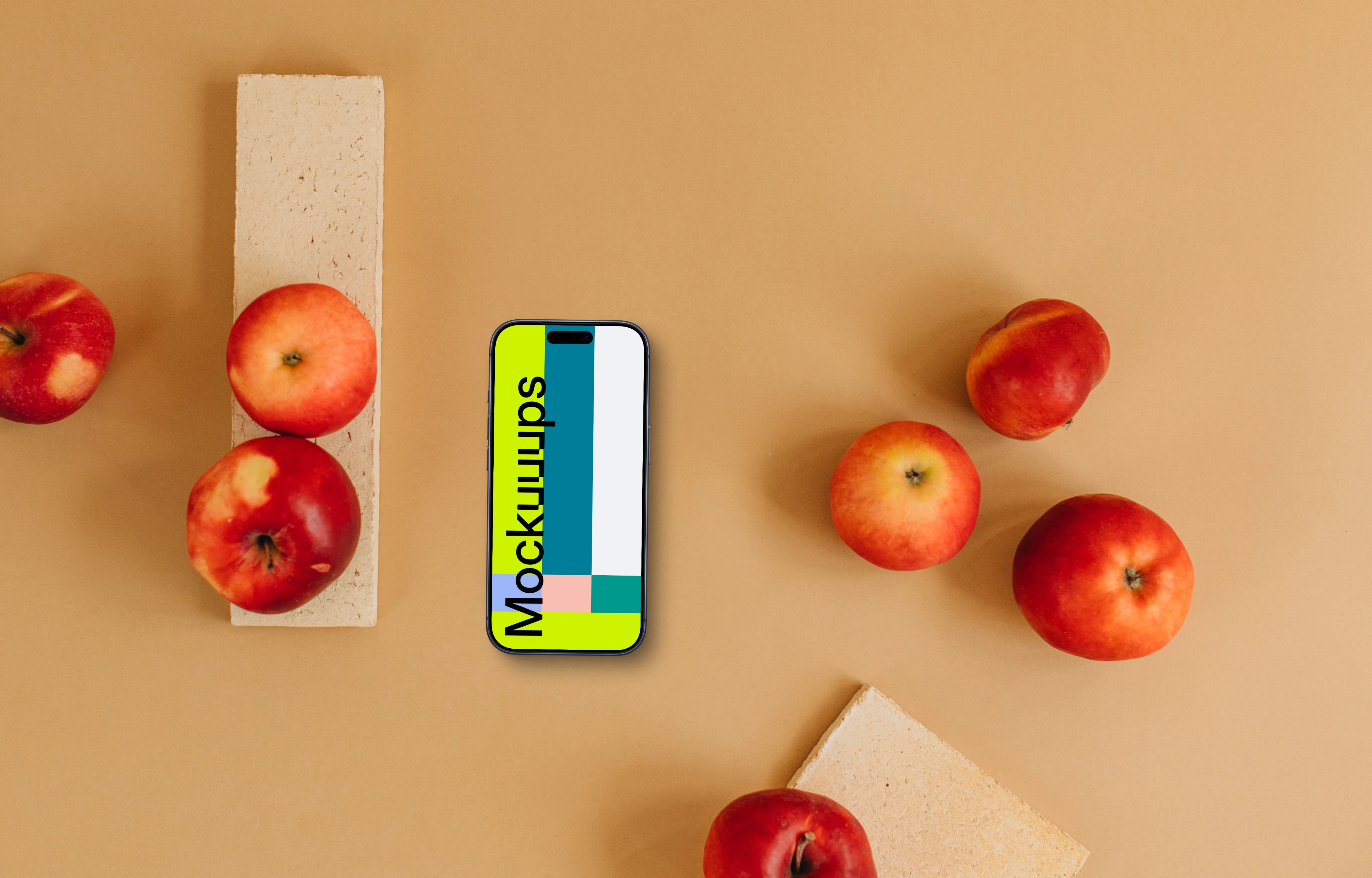Top view of smartphone mockup next to apples