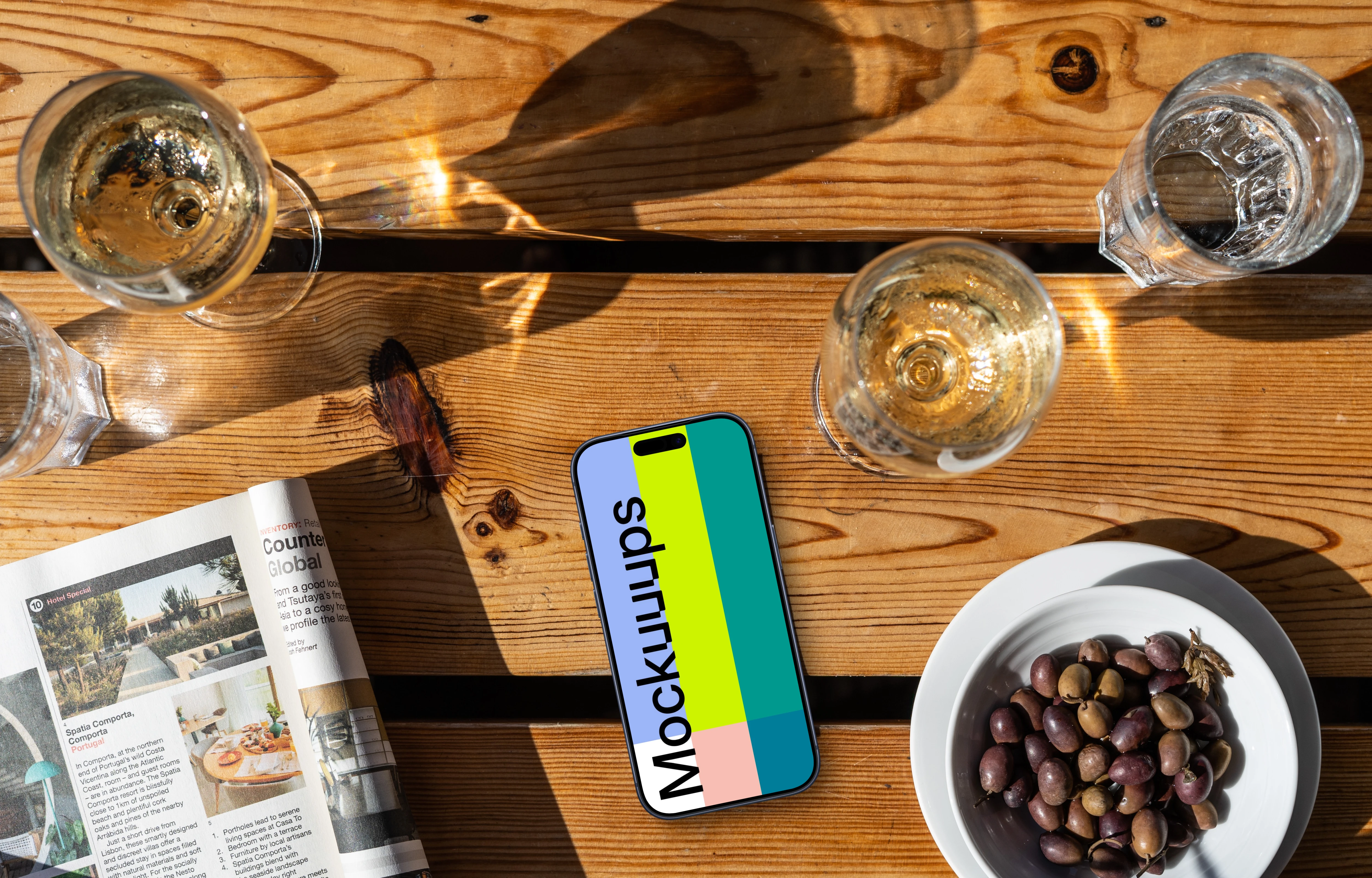 Smartphone mockup next to olives and wine
