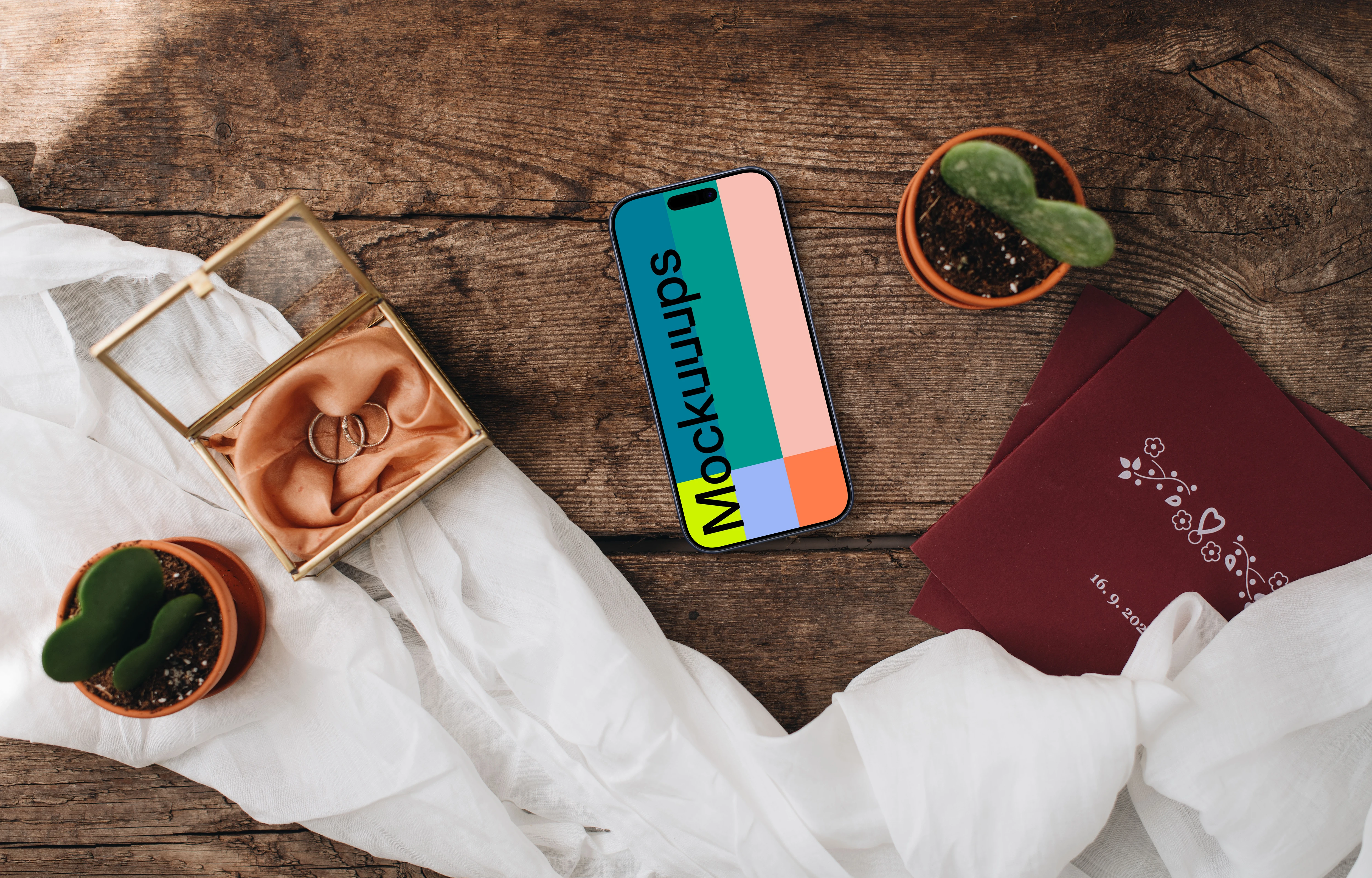 Wedding rings next to an iPhone mockup