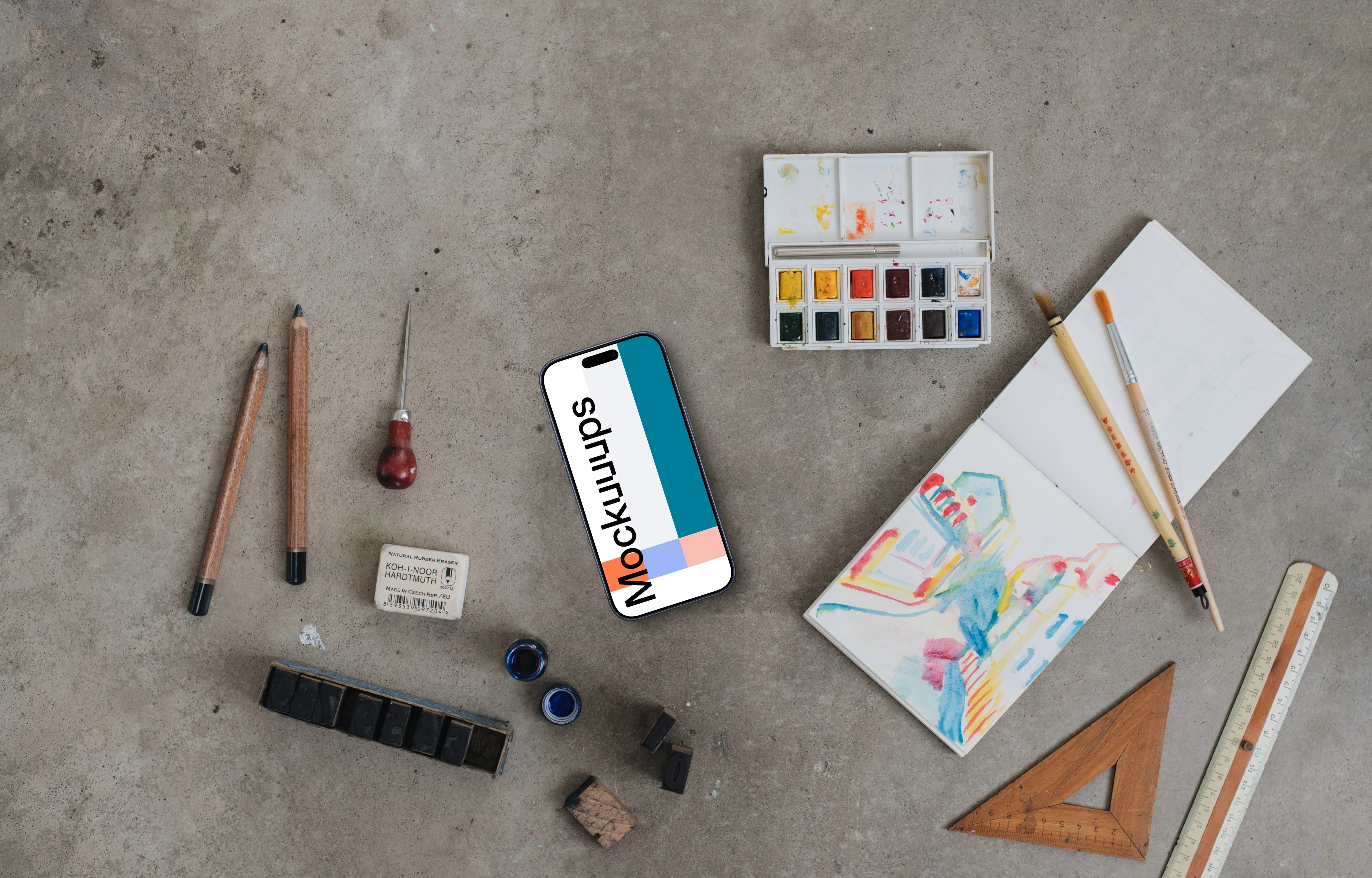Top view of smartphone mockup next to the painting accessories