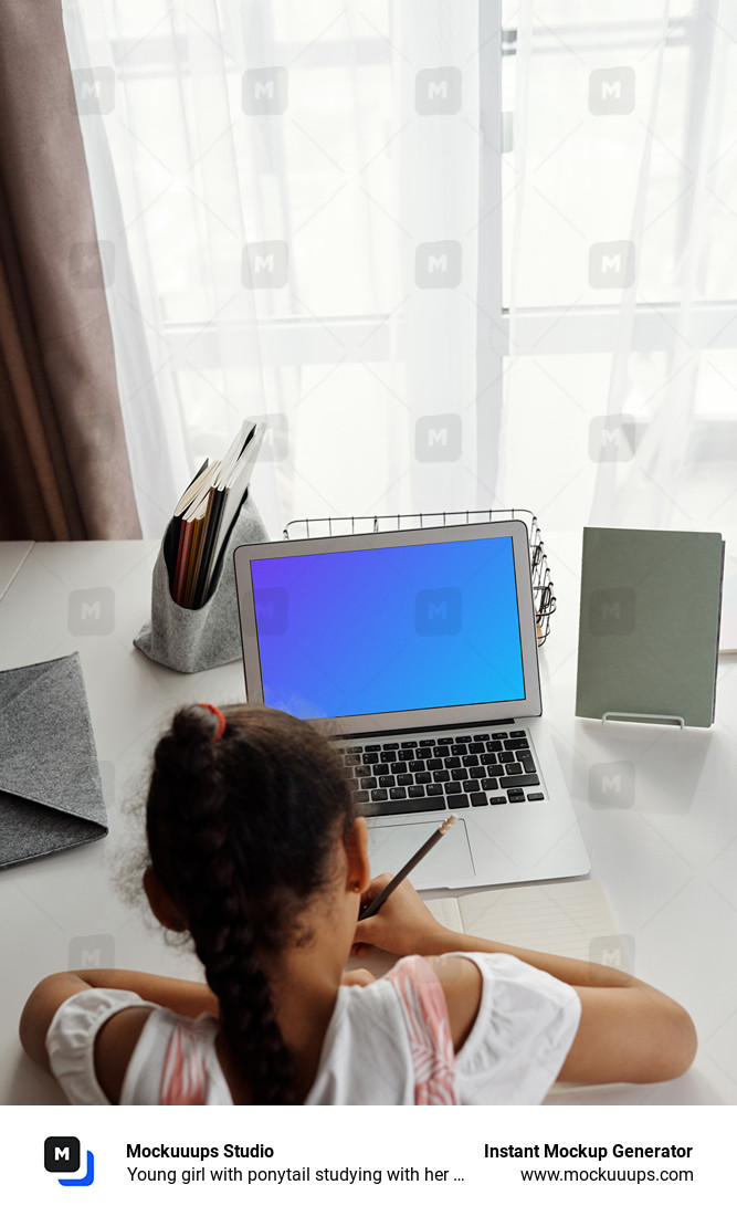 Young girl with ponytail studying with her MacBook Air mockup
