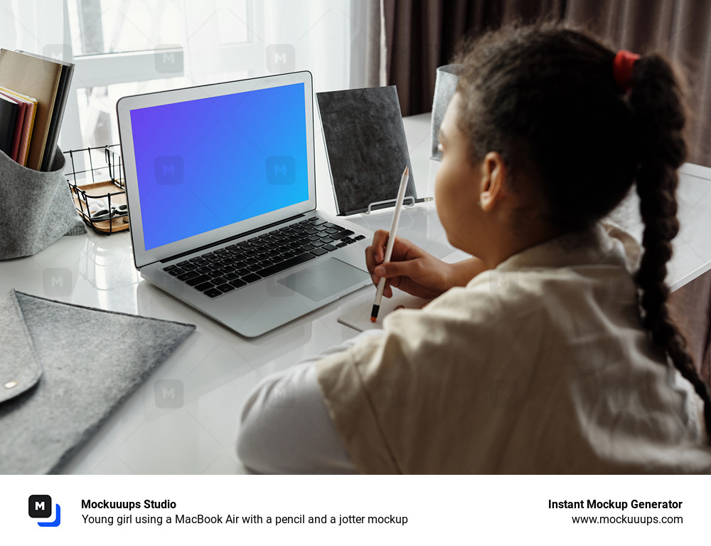 Young girl using a MacBook Air with a pencil and a jotter mockup