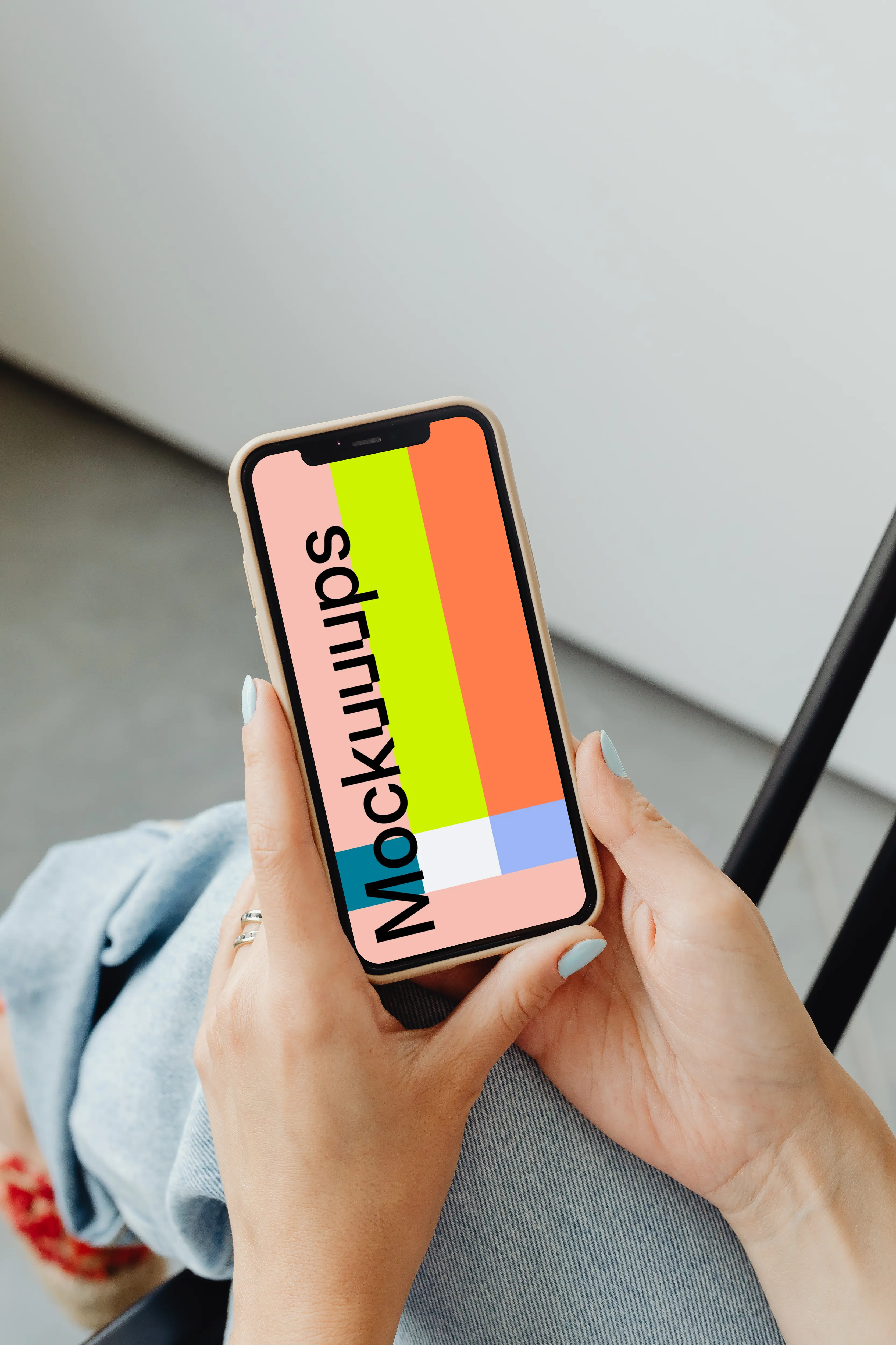 A simple handheld iPhone mockup help above the laps of a user