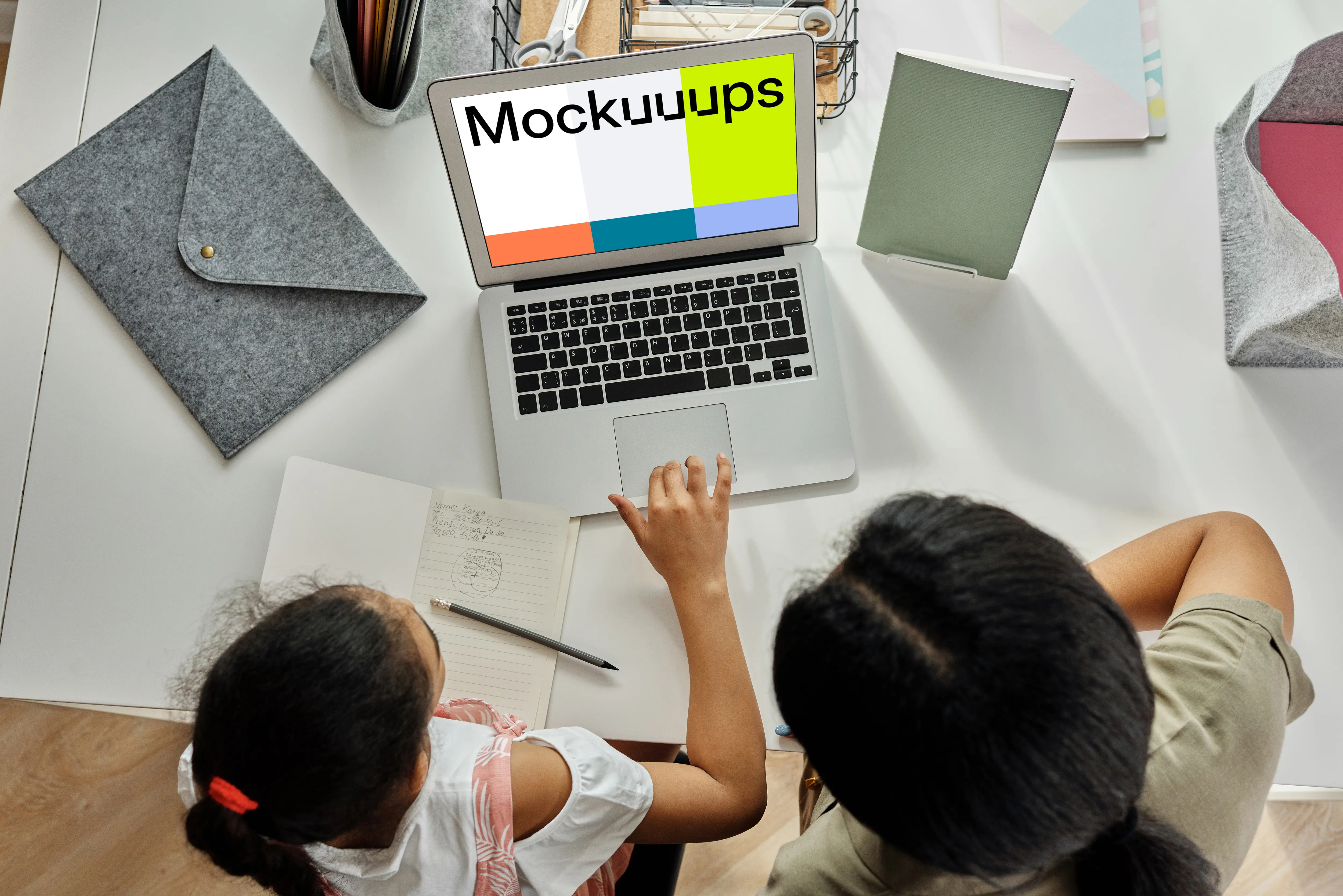 Adult teaching a young girl something on a MacBook Air mockup