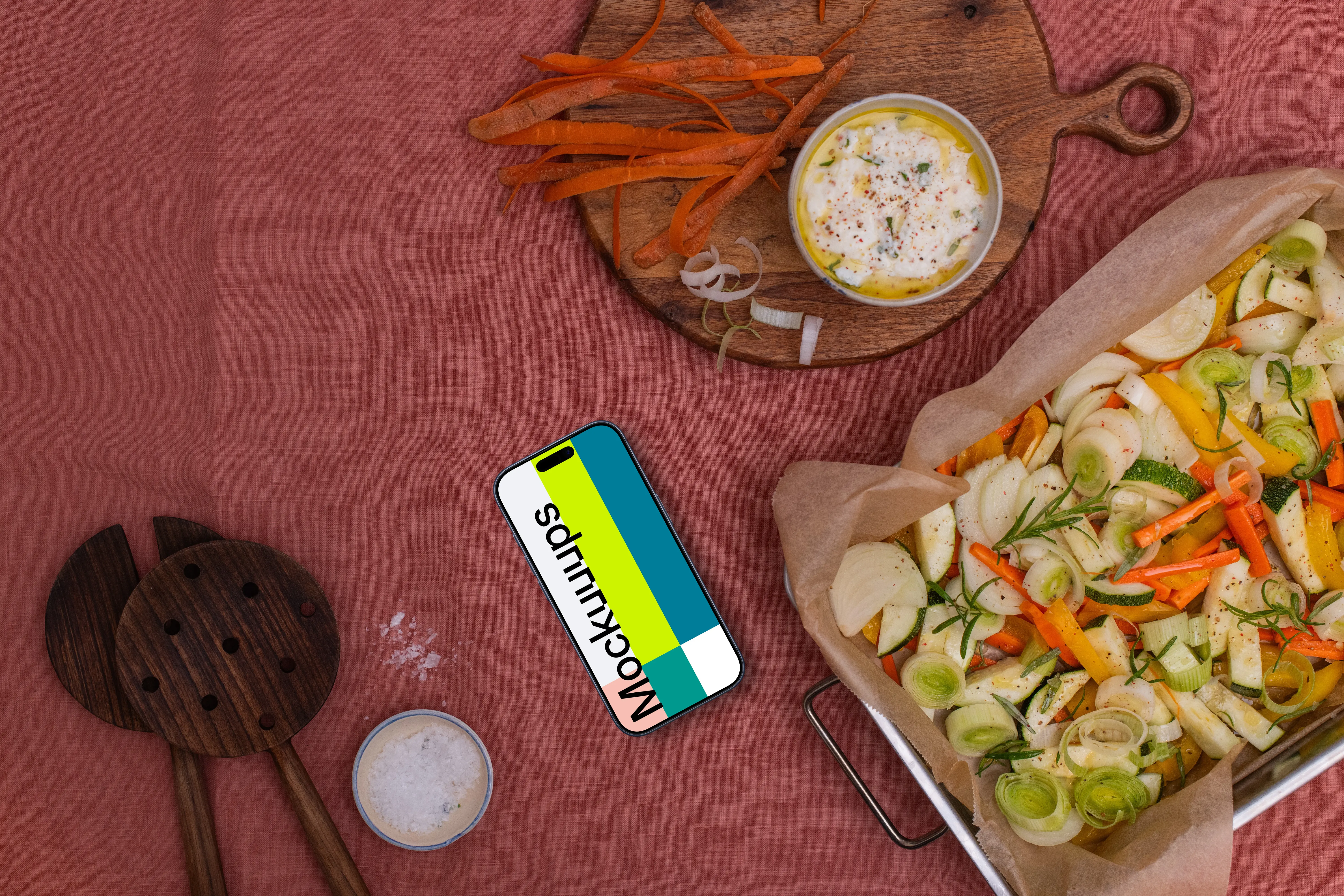 Baking pan full of vegetables and a phone mockup