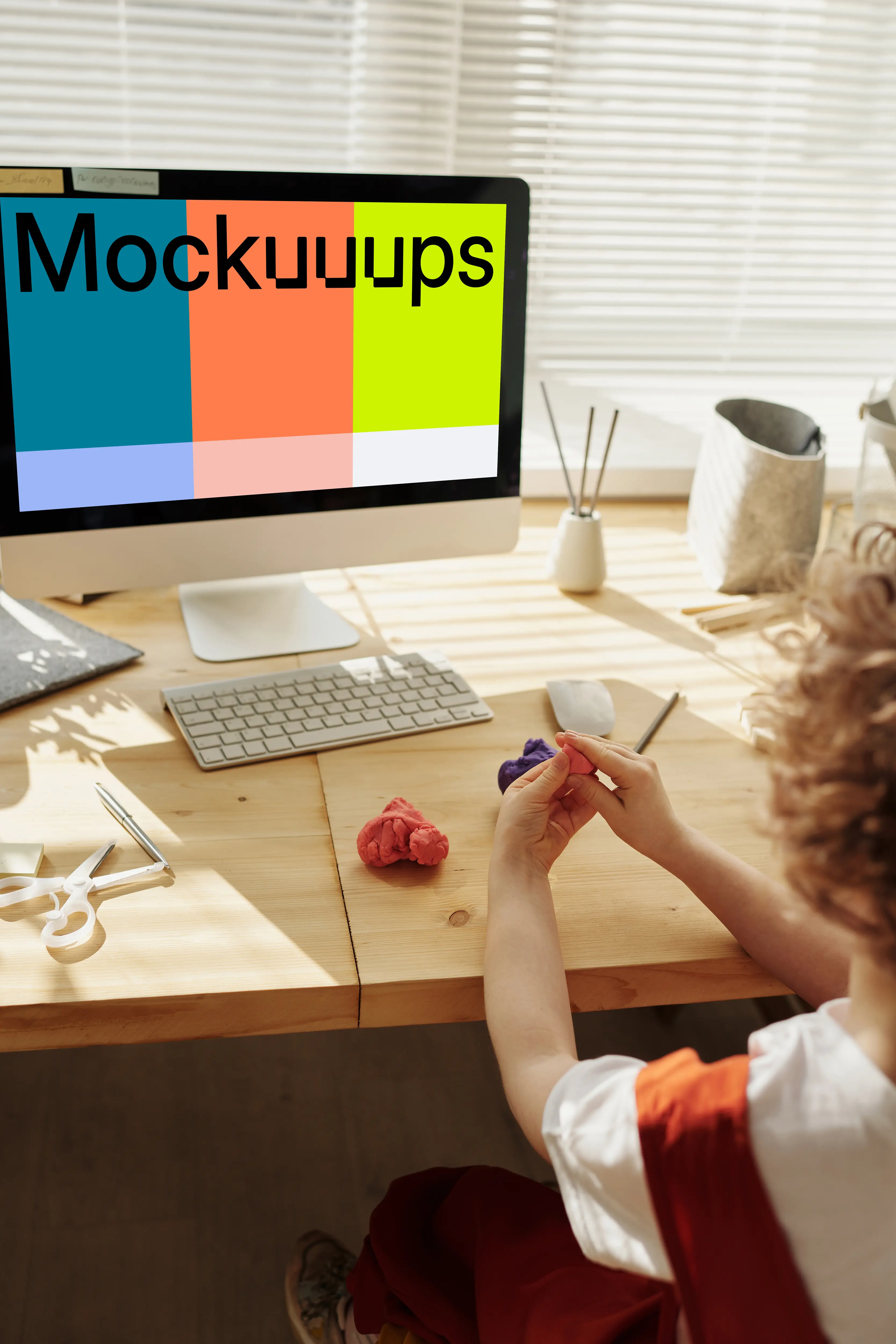Child playing in front of an iMac computer mockup