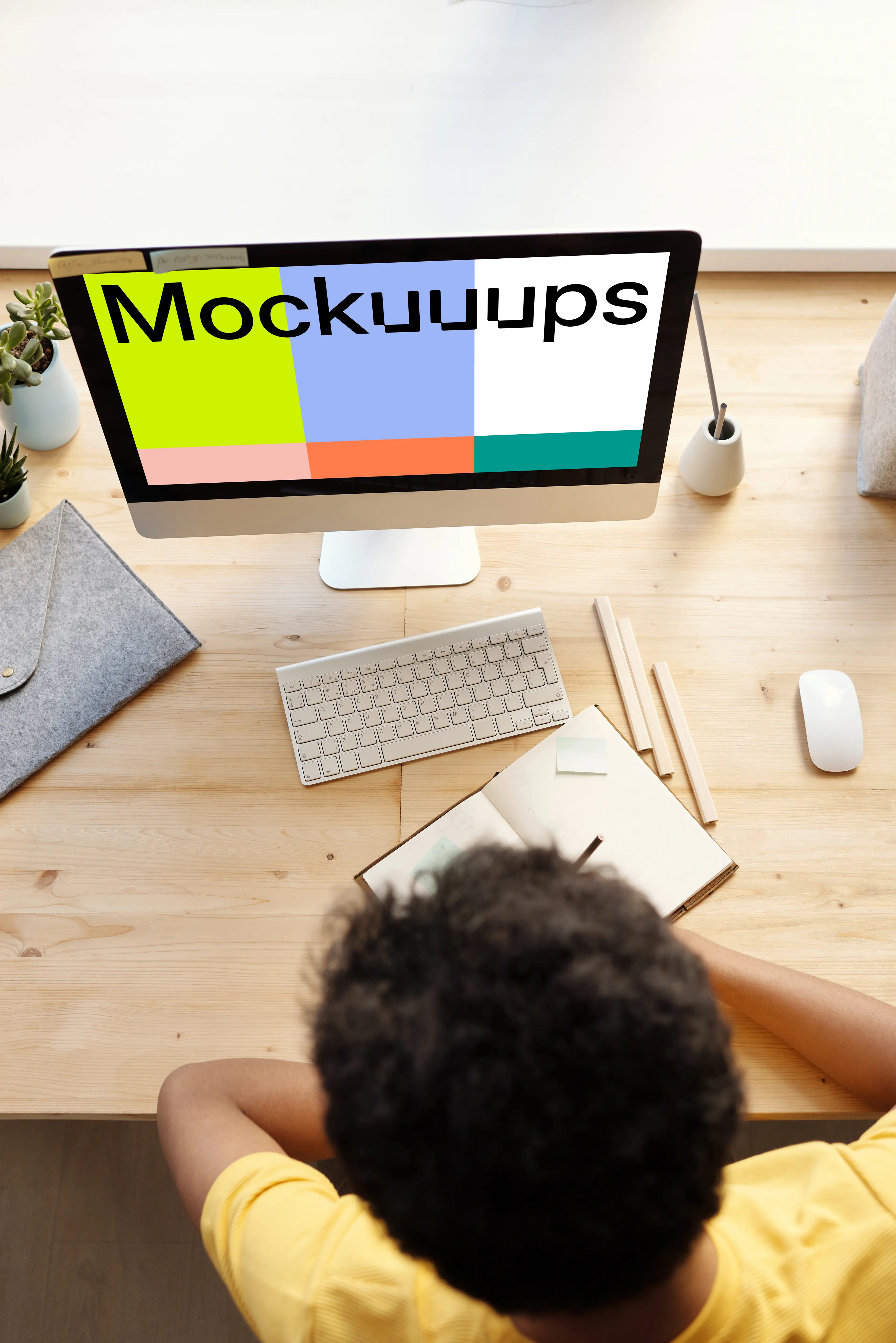 Dark haired kid using an iMac mockup