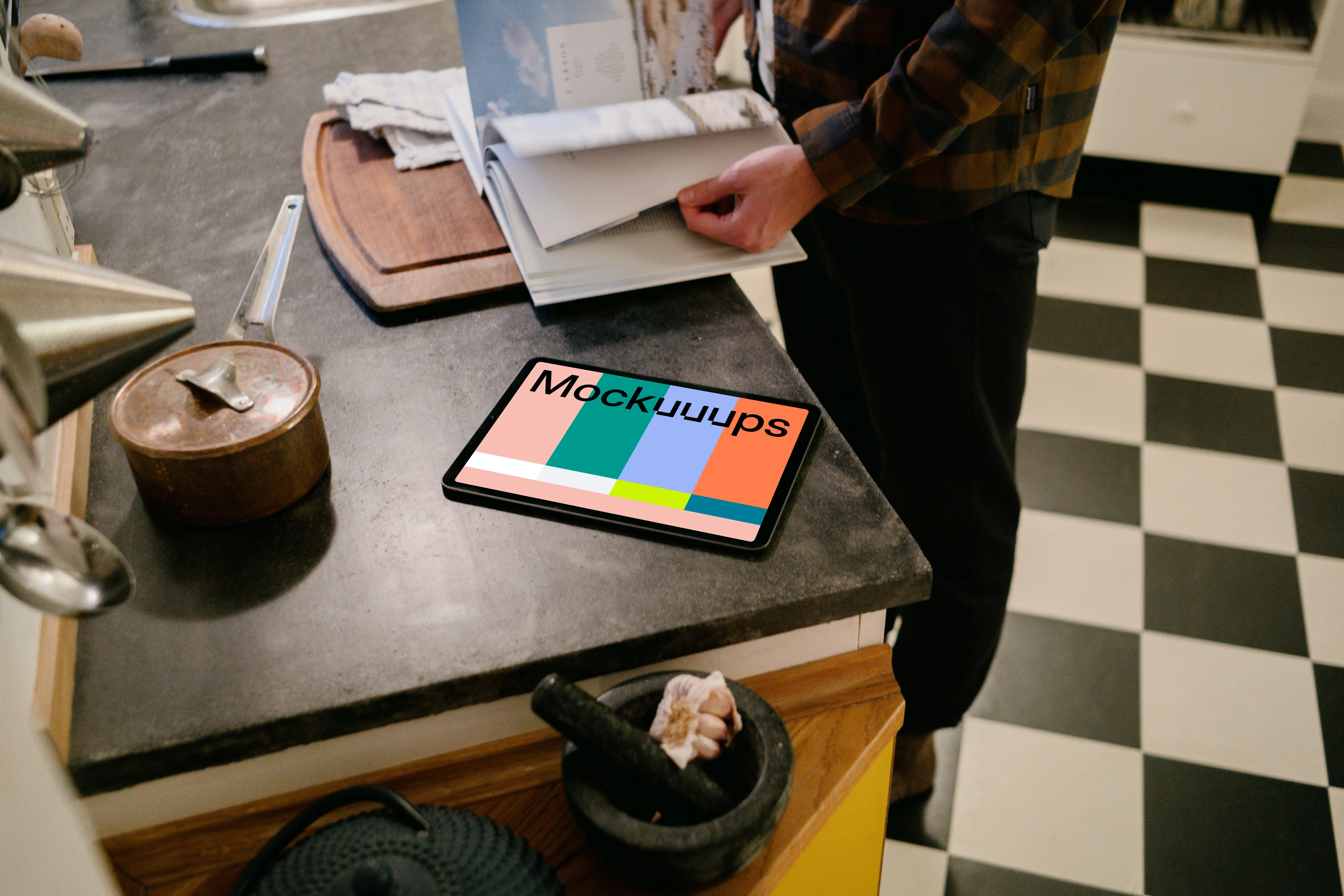 iPad Air mockup on a kitchen table beside a male user.
