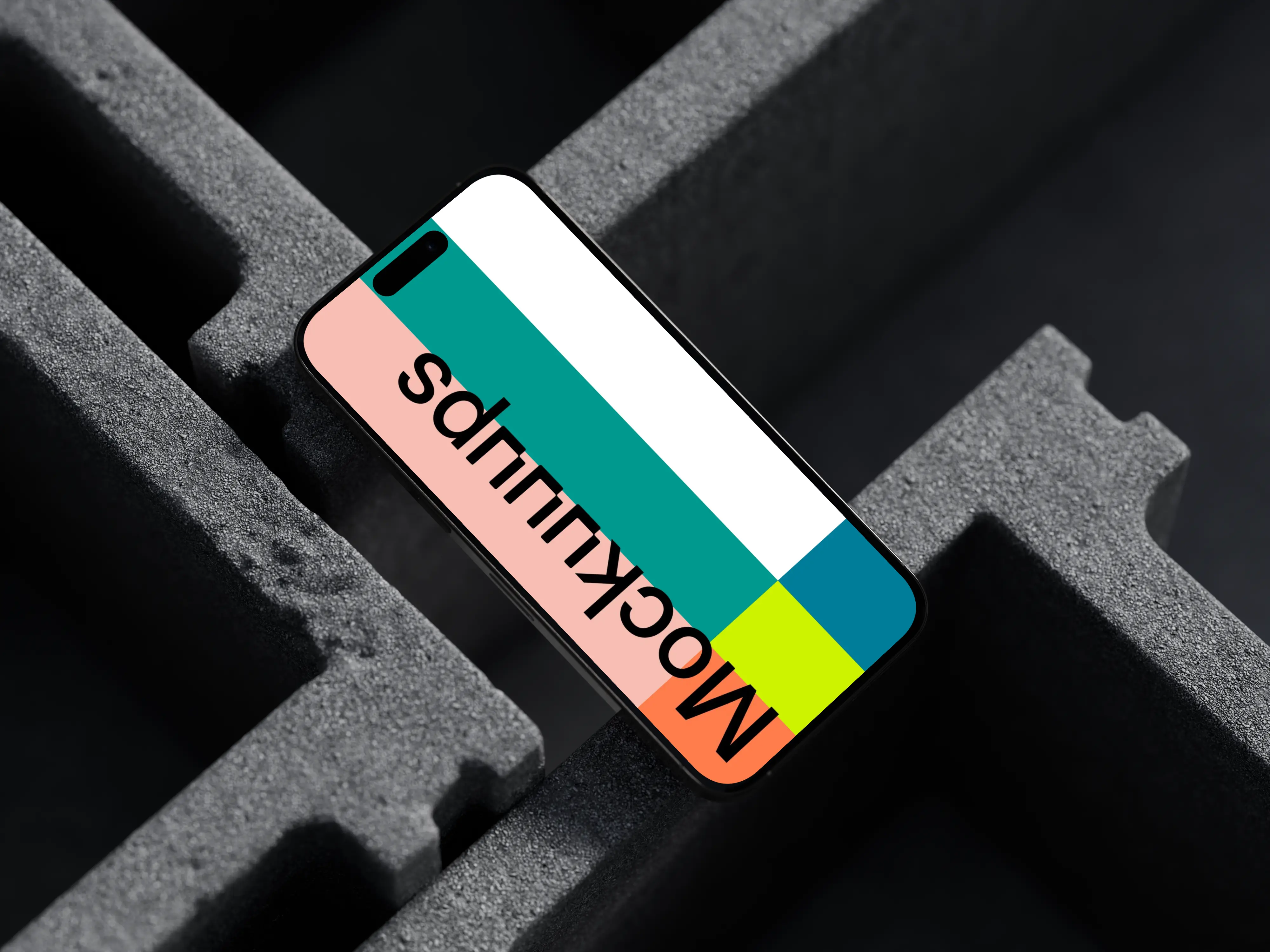 iPhone 16 mockup placed on concrete blocks