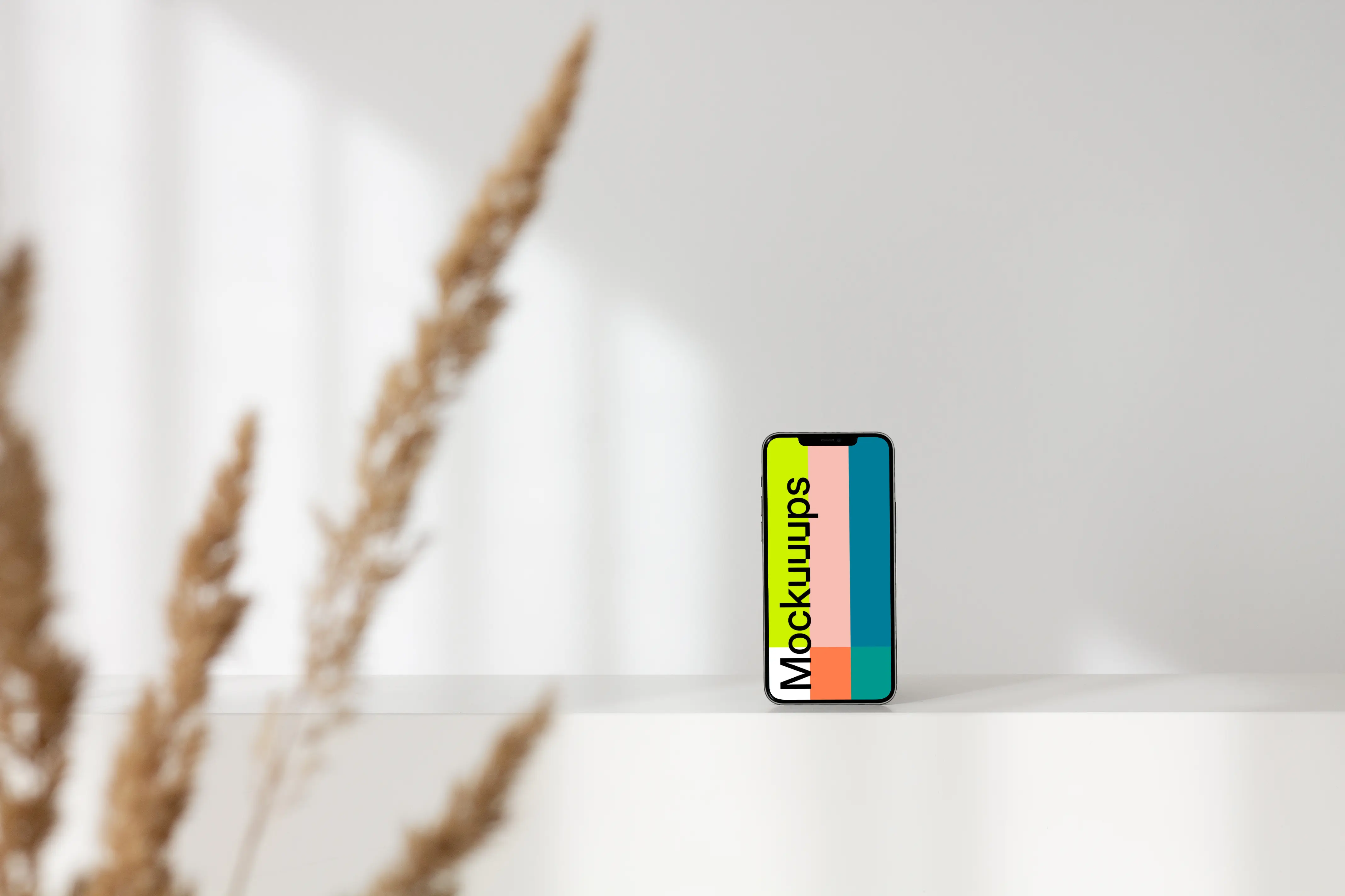 iPhone leaning on a white wall mockup