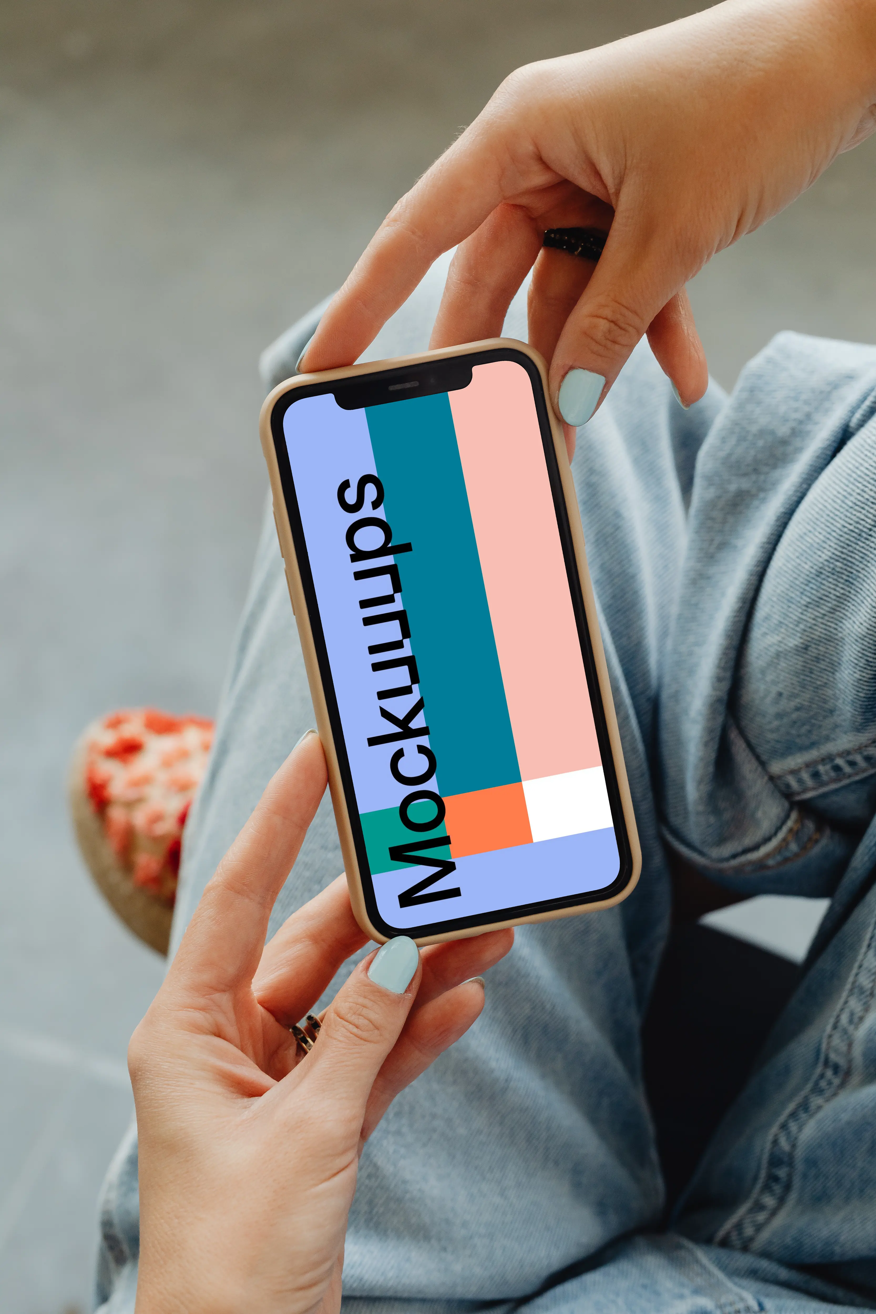 iPhone mockup hand held by user above her laps