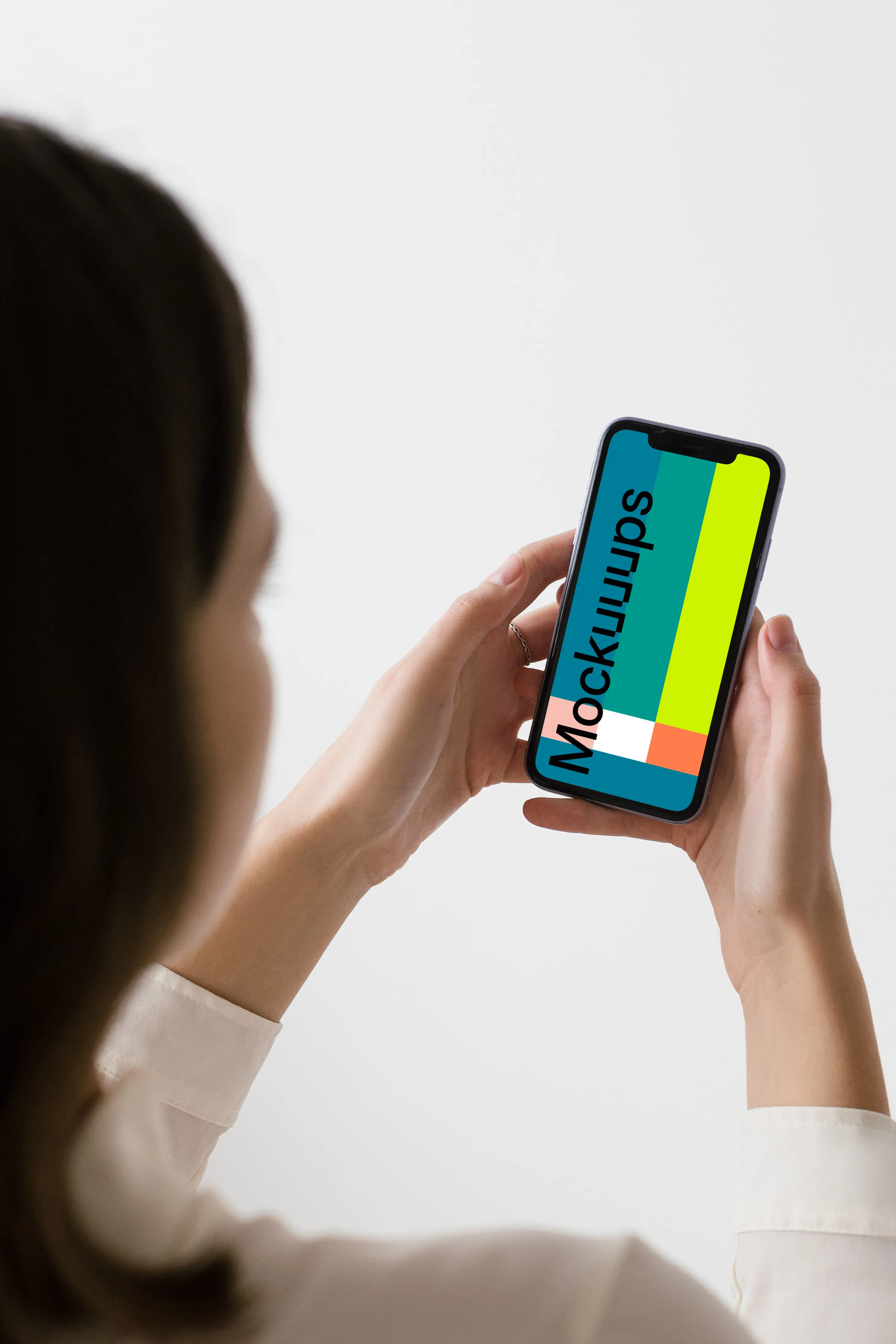 iPhone mockup held up by a woman