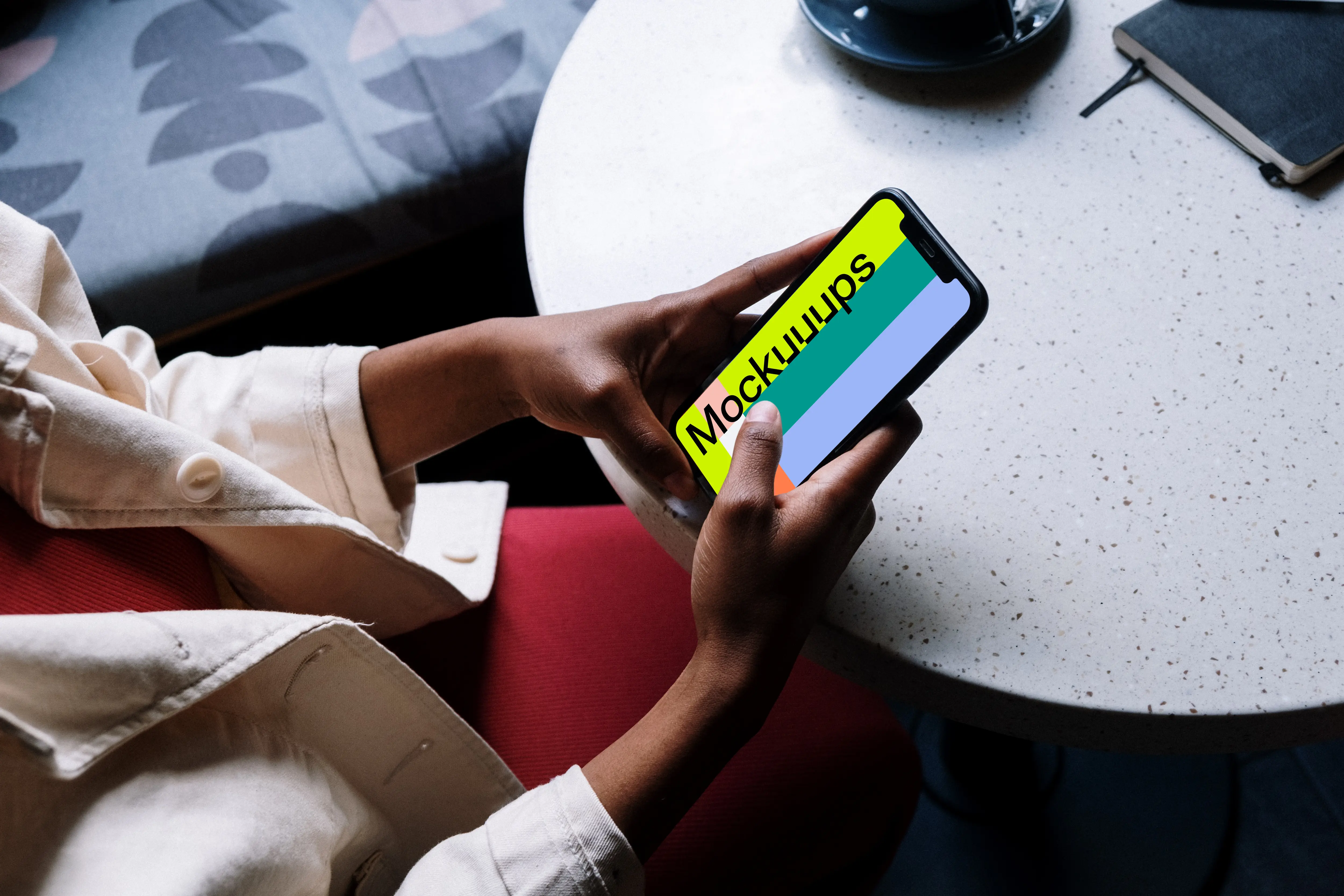 iPhone mockup in a dark-skinned females hand