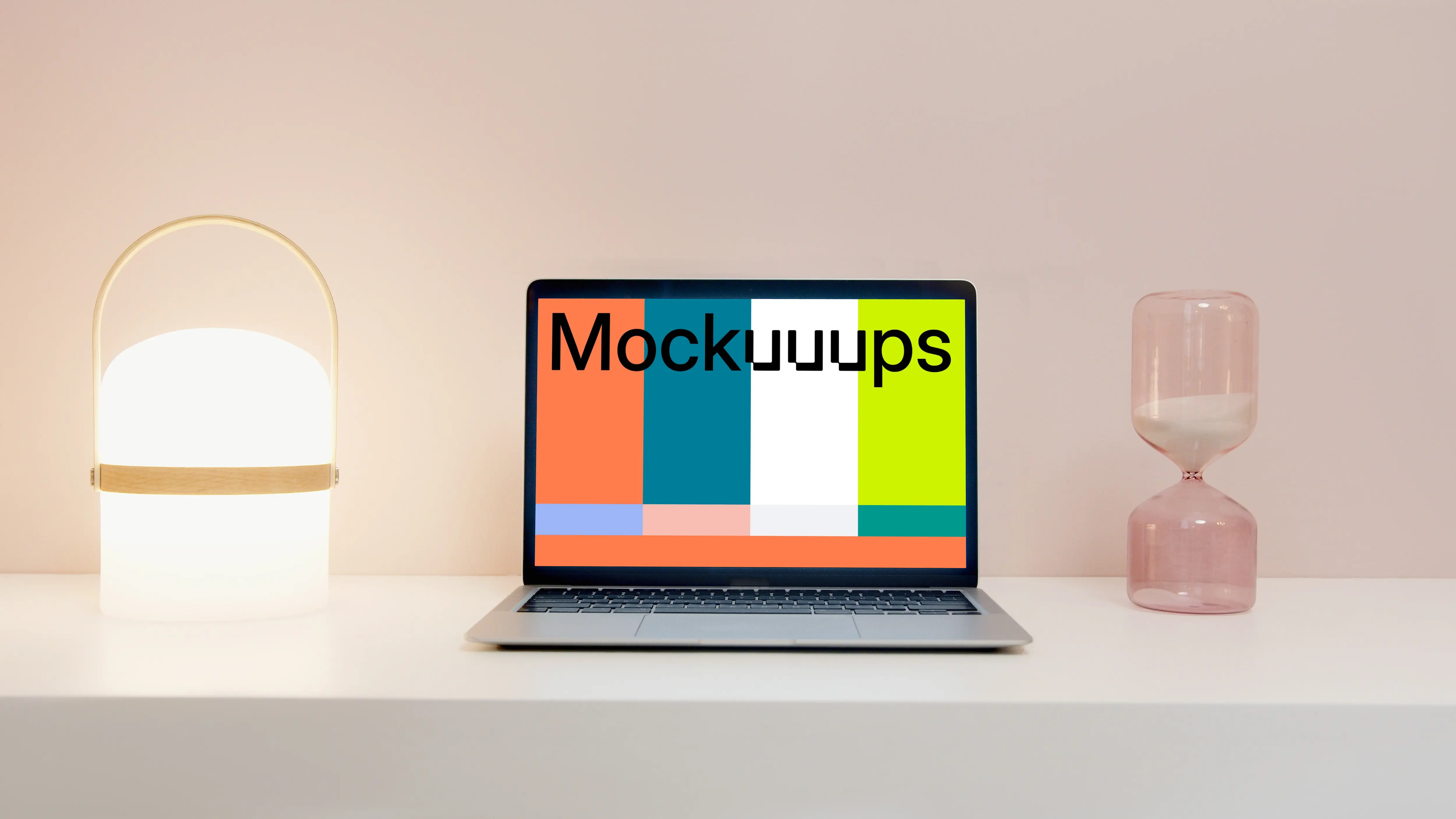 MacBook Pro mockup on a table beside an hourglass