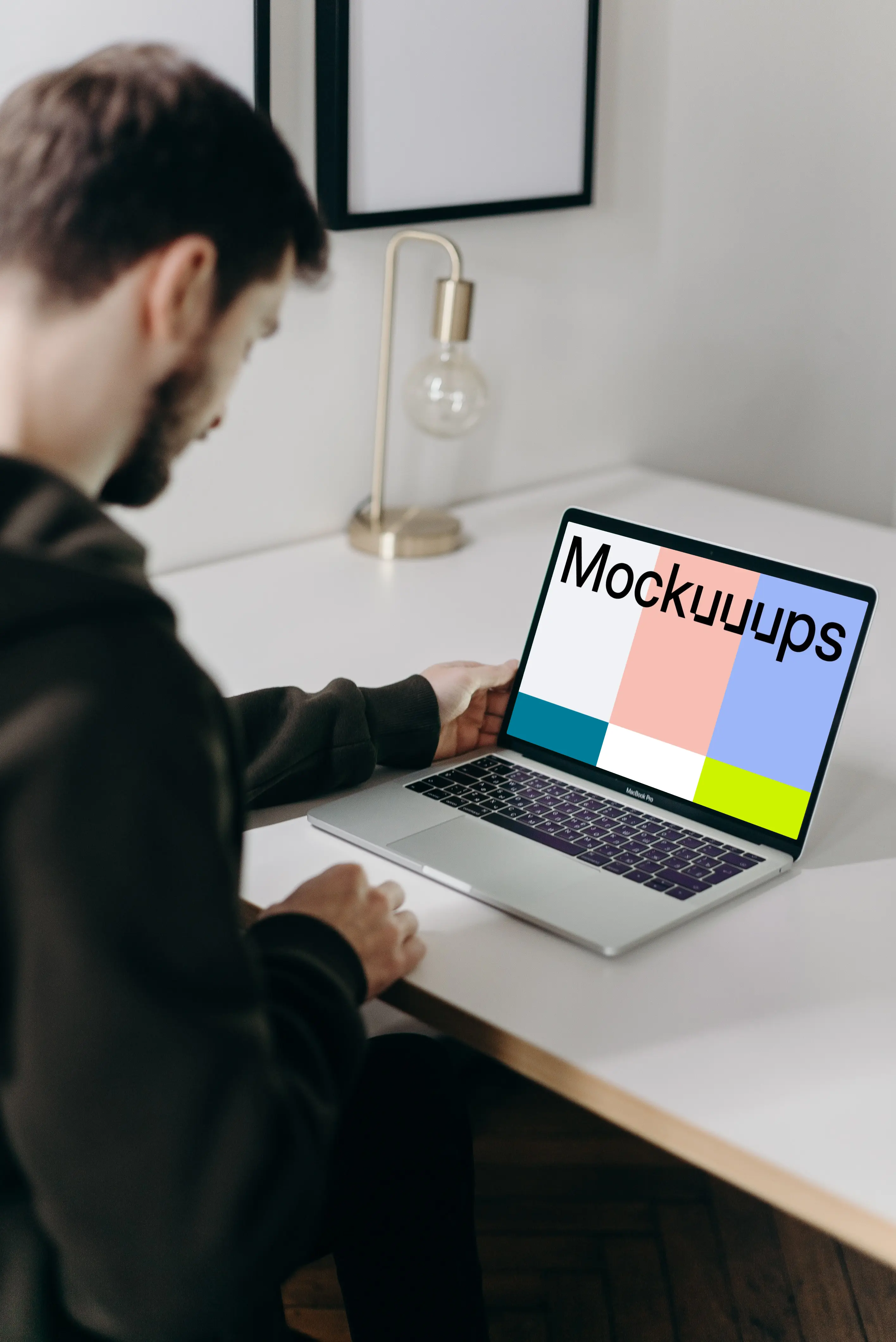 MacBook Pro mockup on a white table facing a mirror