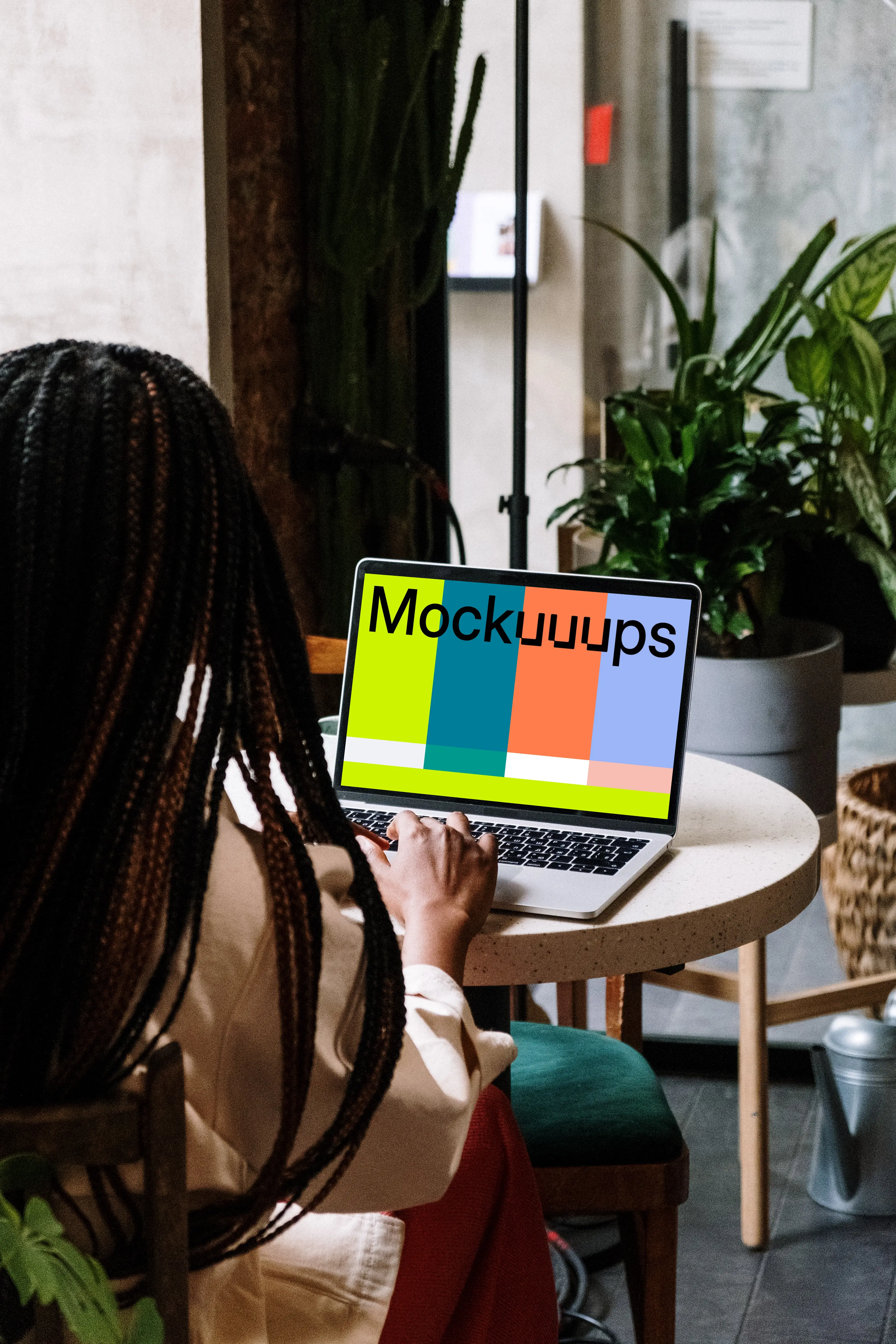MacBook Pro mockup on white table with notebook by the side