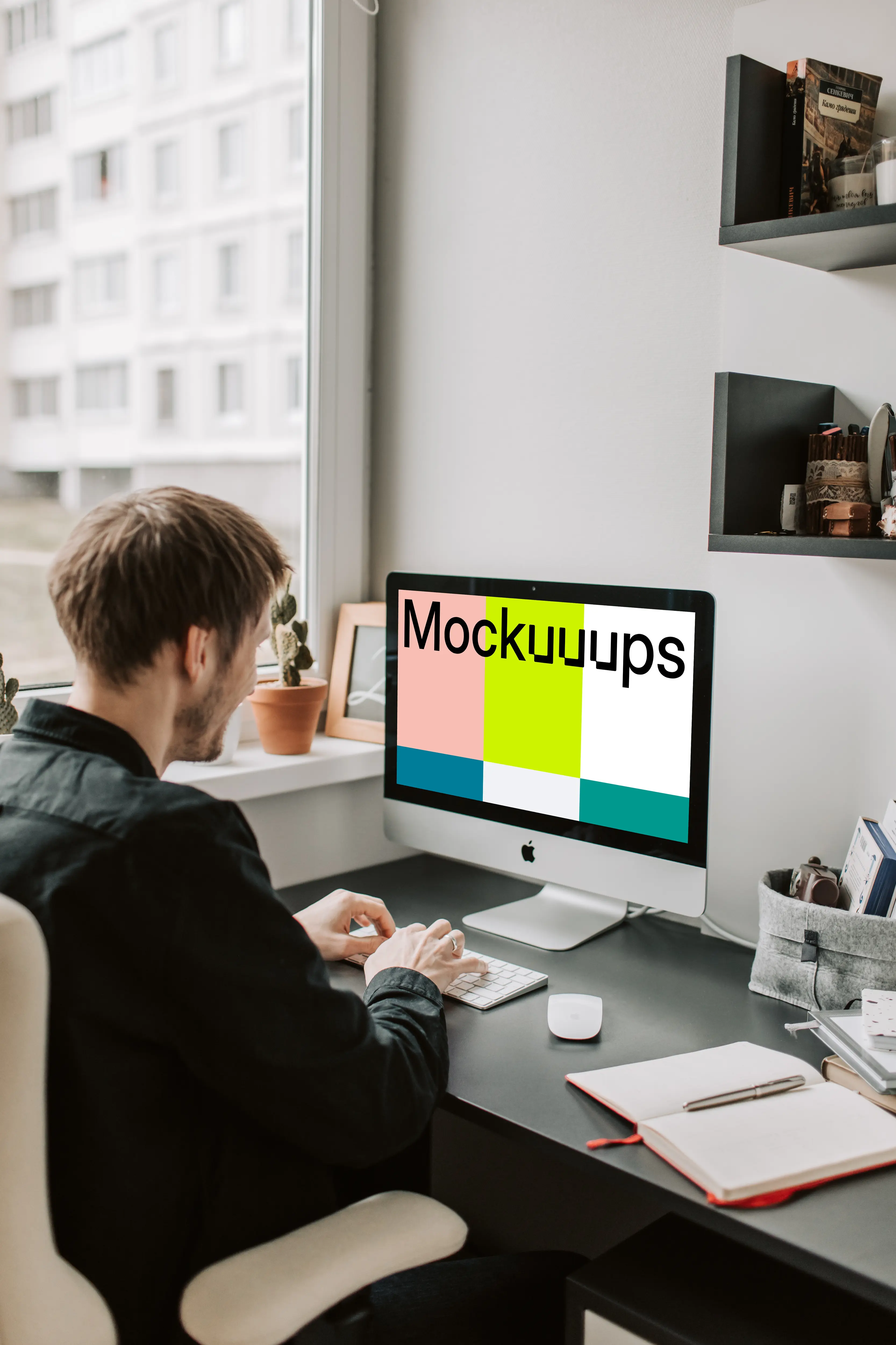 Man typing into his iMac mockup