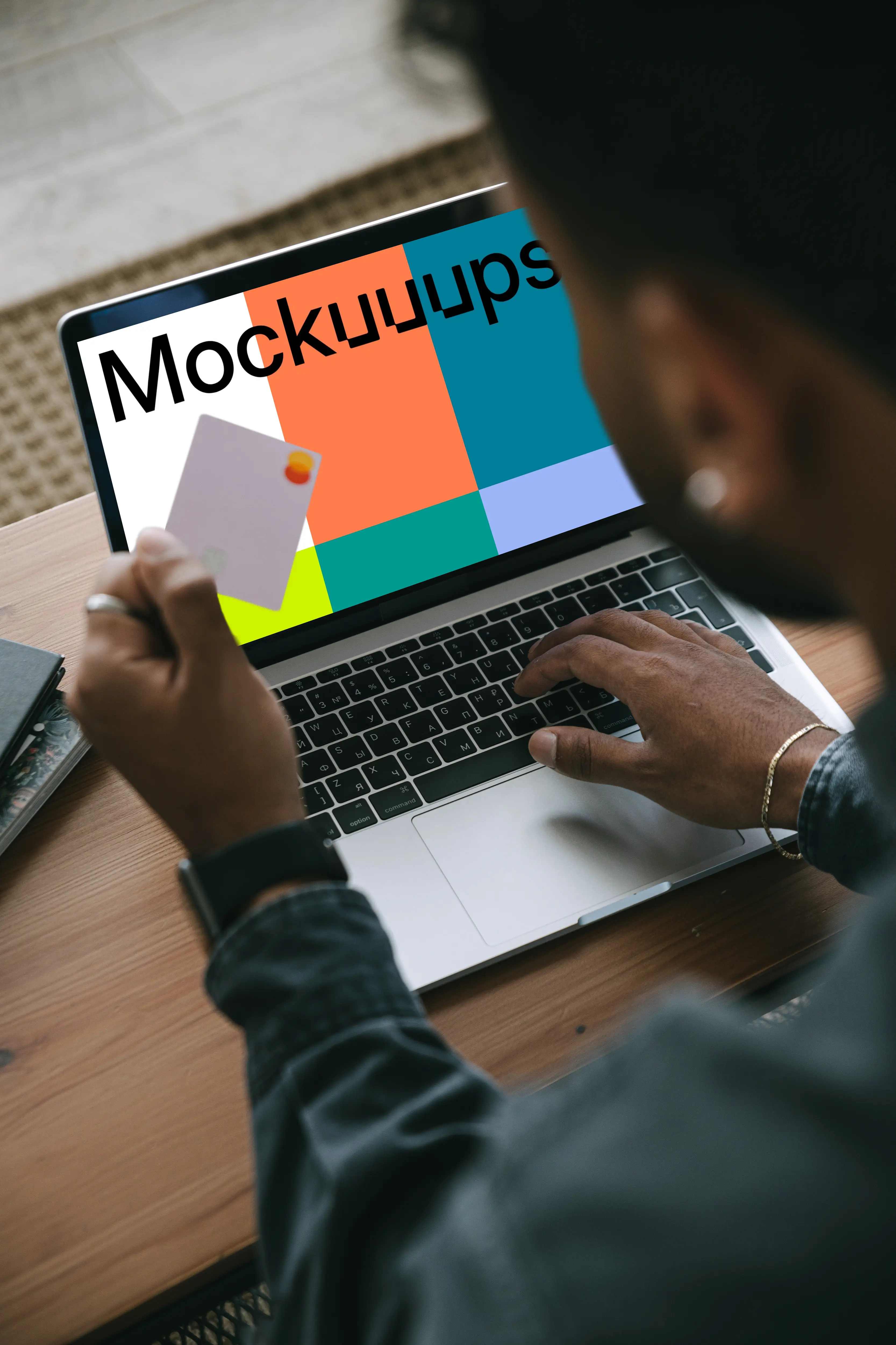 Mockup of man entering his card details into his MacBook 