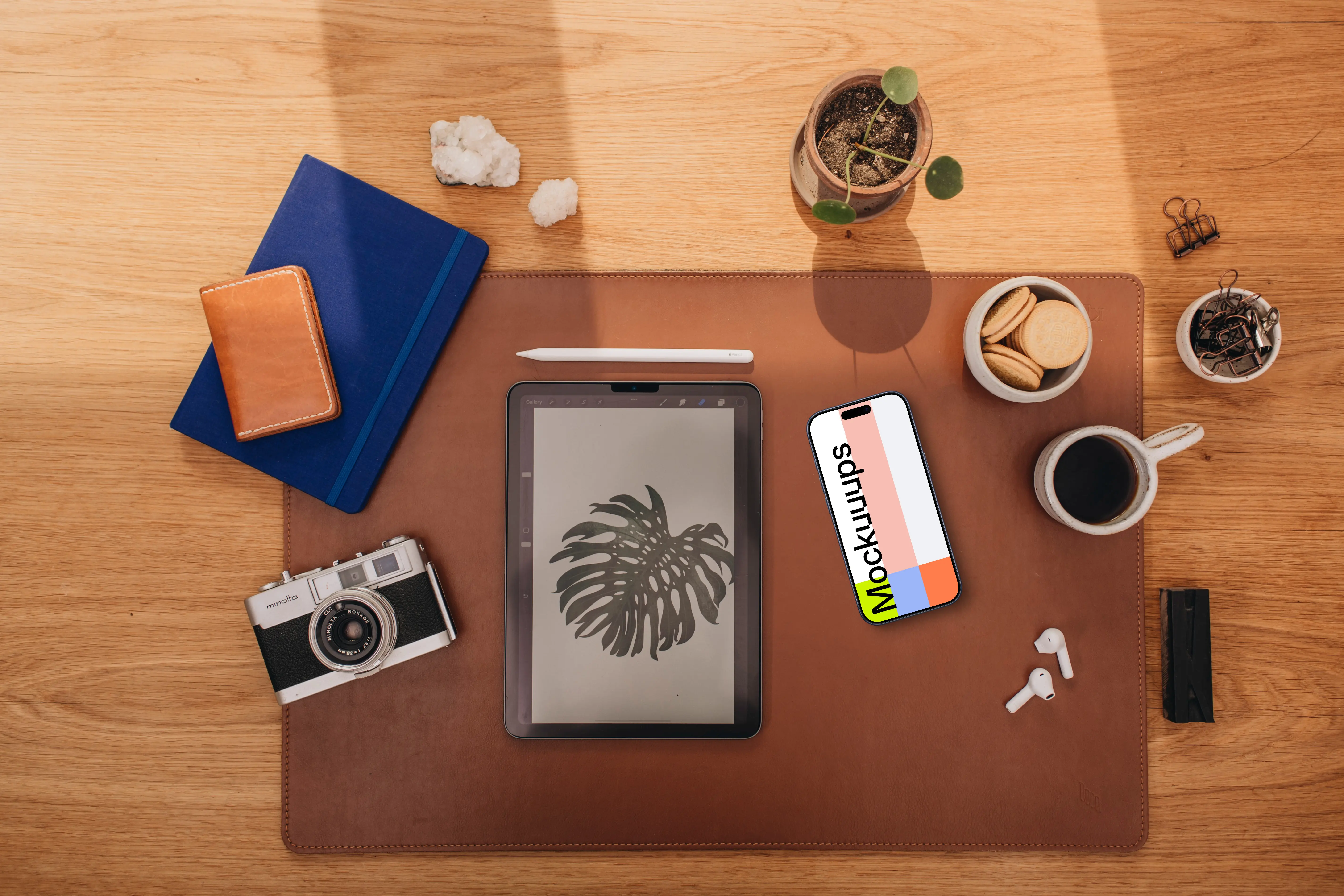 Mockup of phone next to the coffee and tablet