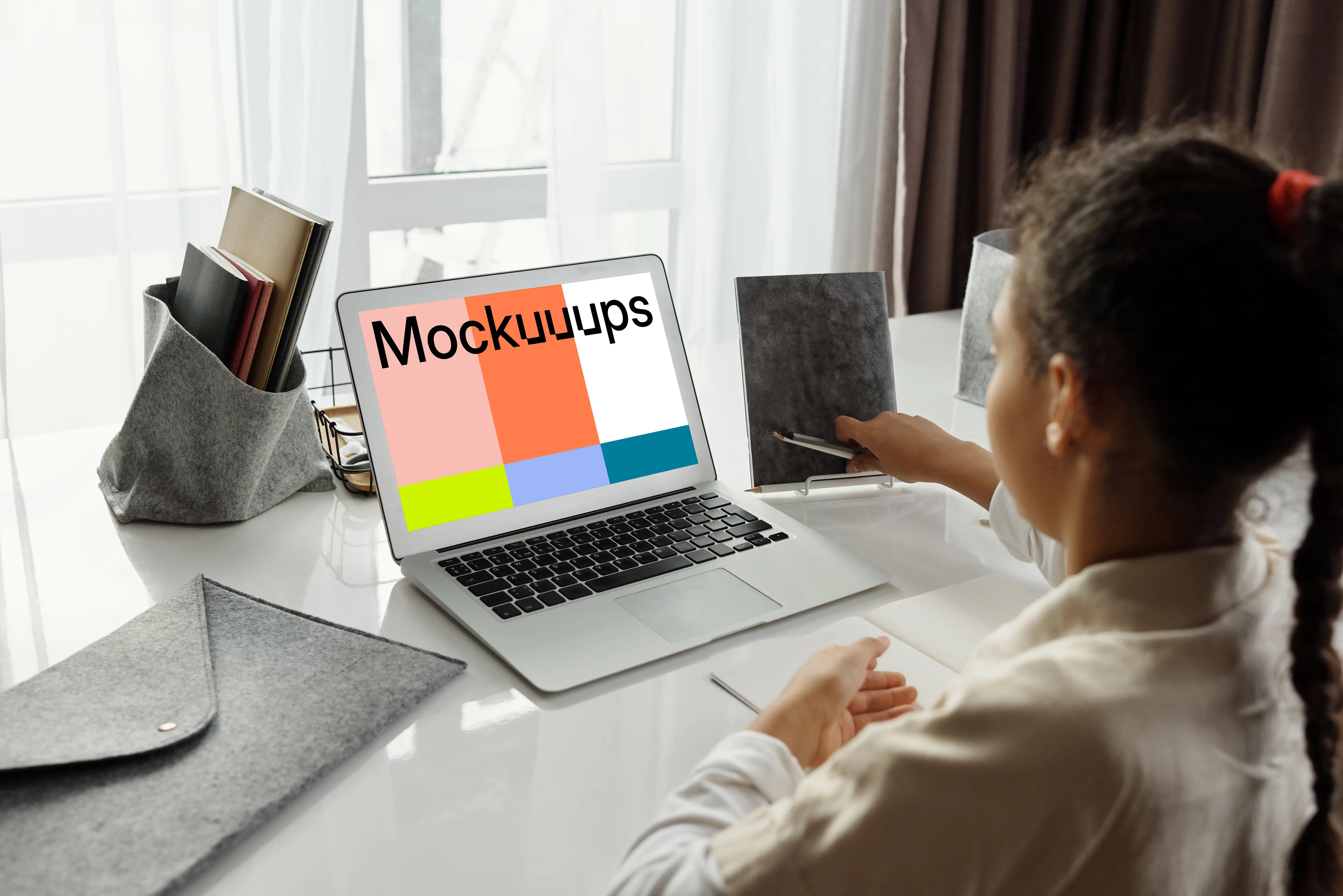 Mockup of young girl using a white MacBook Air