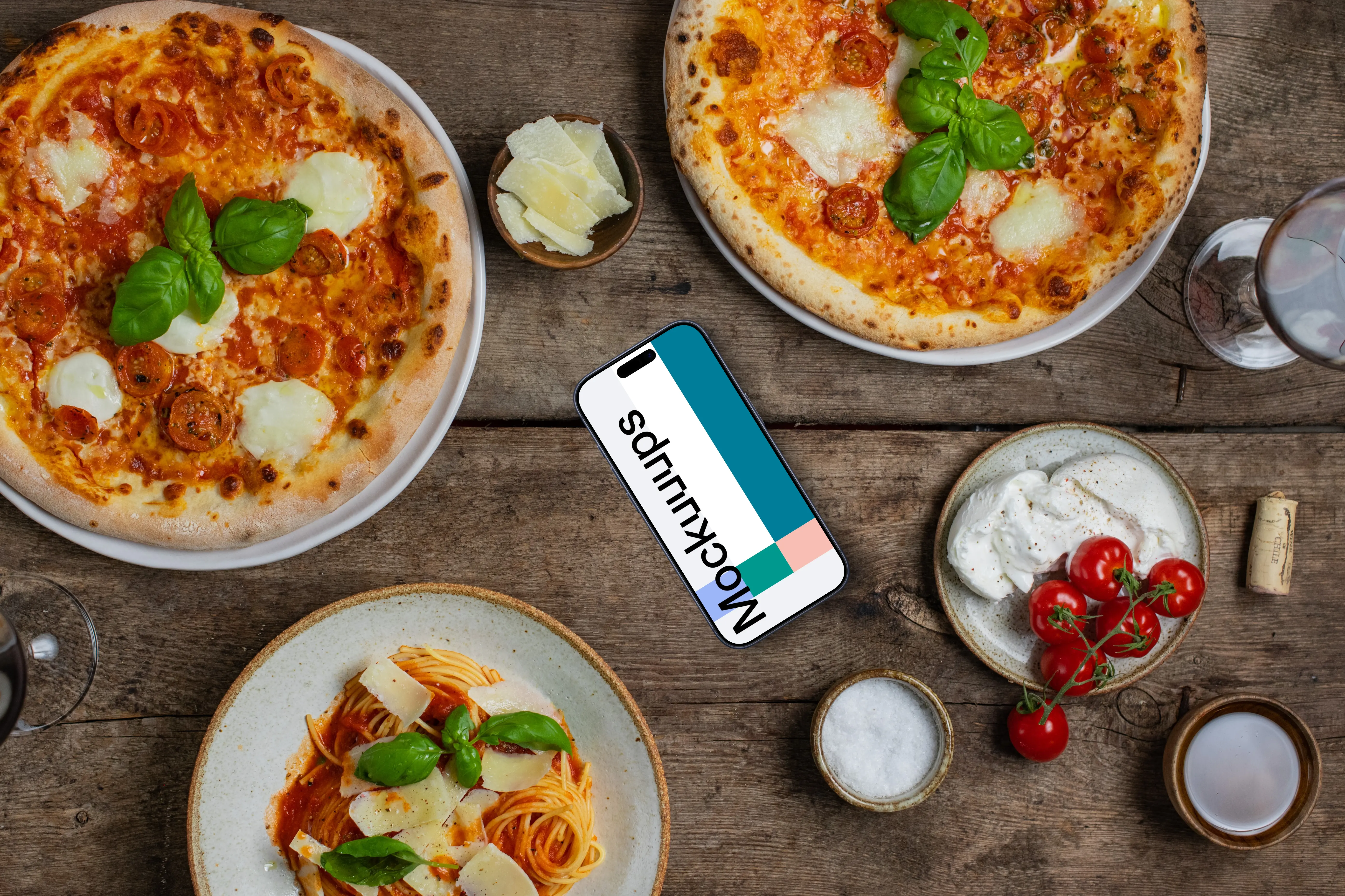 Phone mockup nearby pizza and pasta