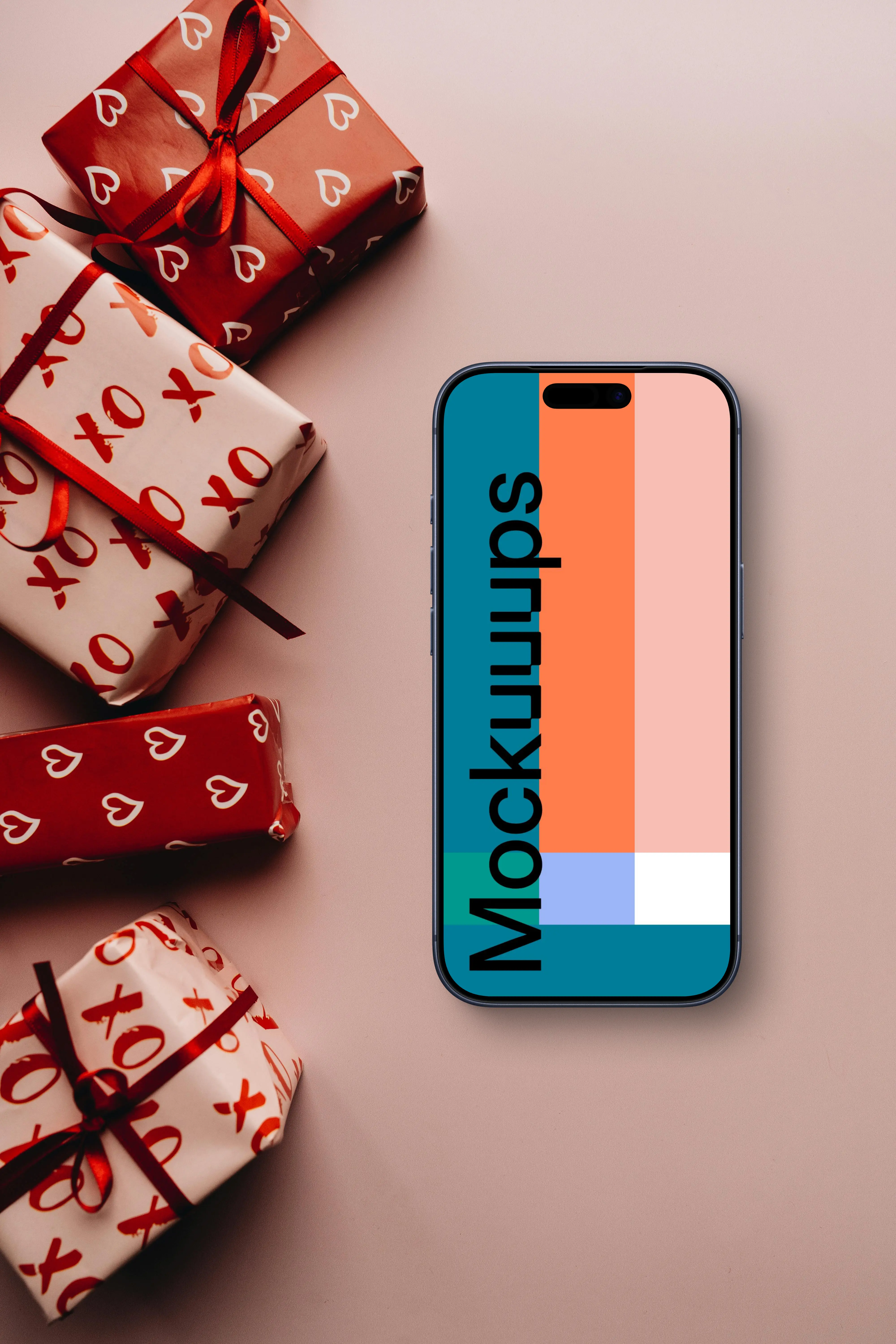 Smartphone mockup next to wrapped romantic gifts