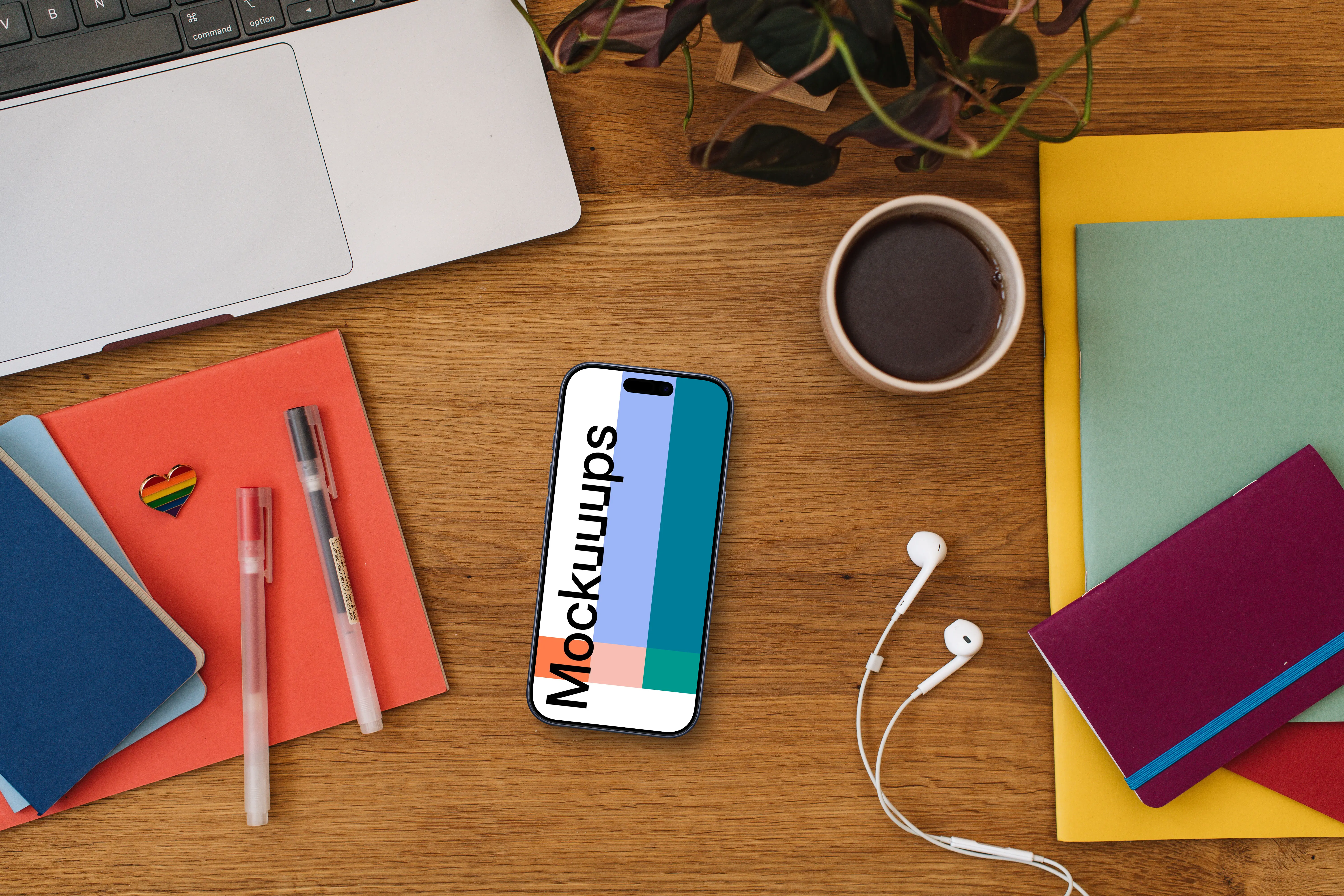 Smartphone mockup on a wooden table together with LGBT pin