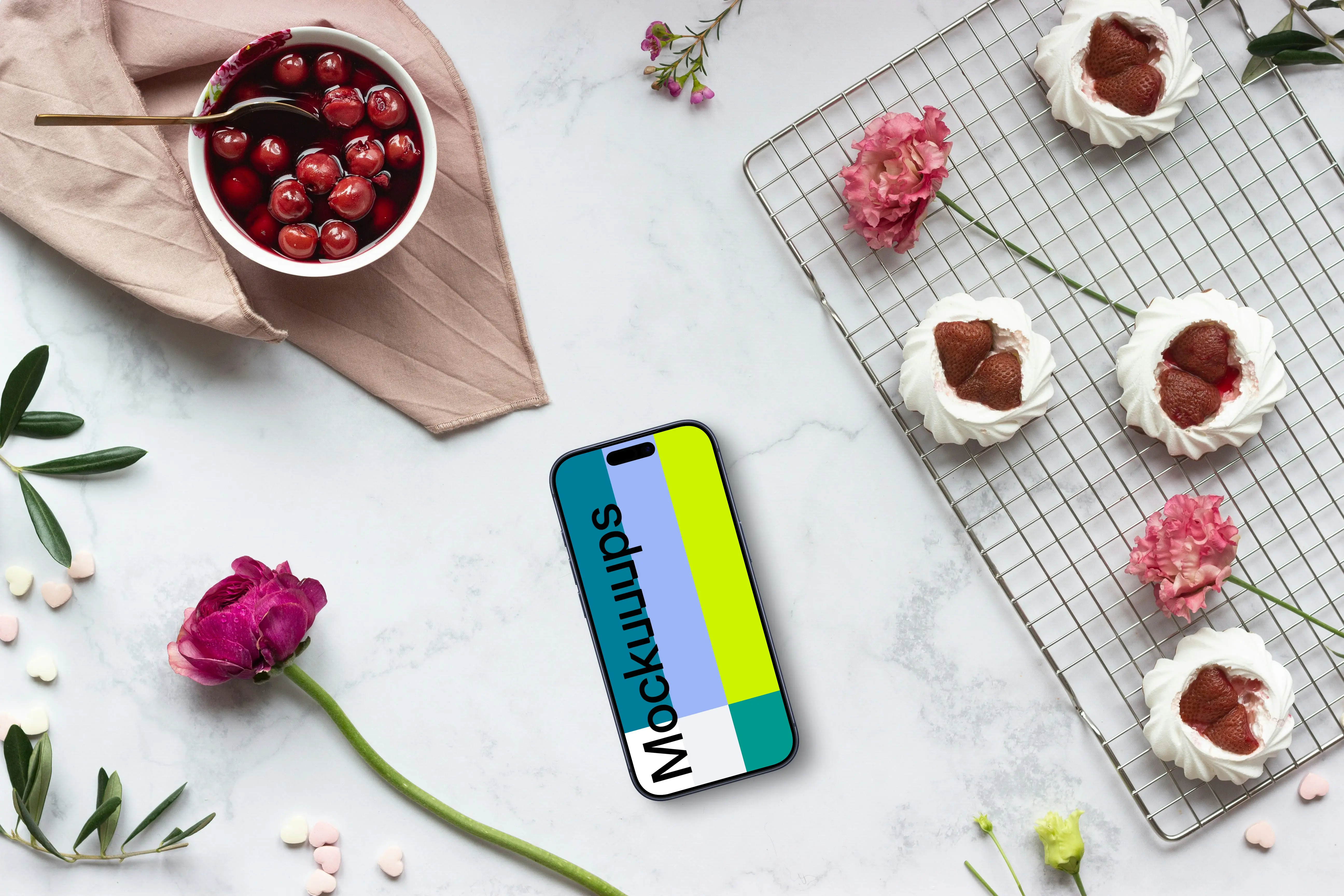 Smartphone mockup with pink flowers and desserts