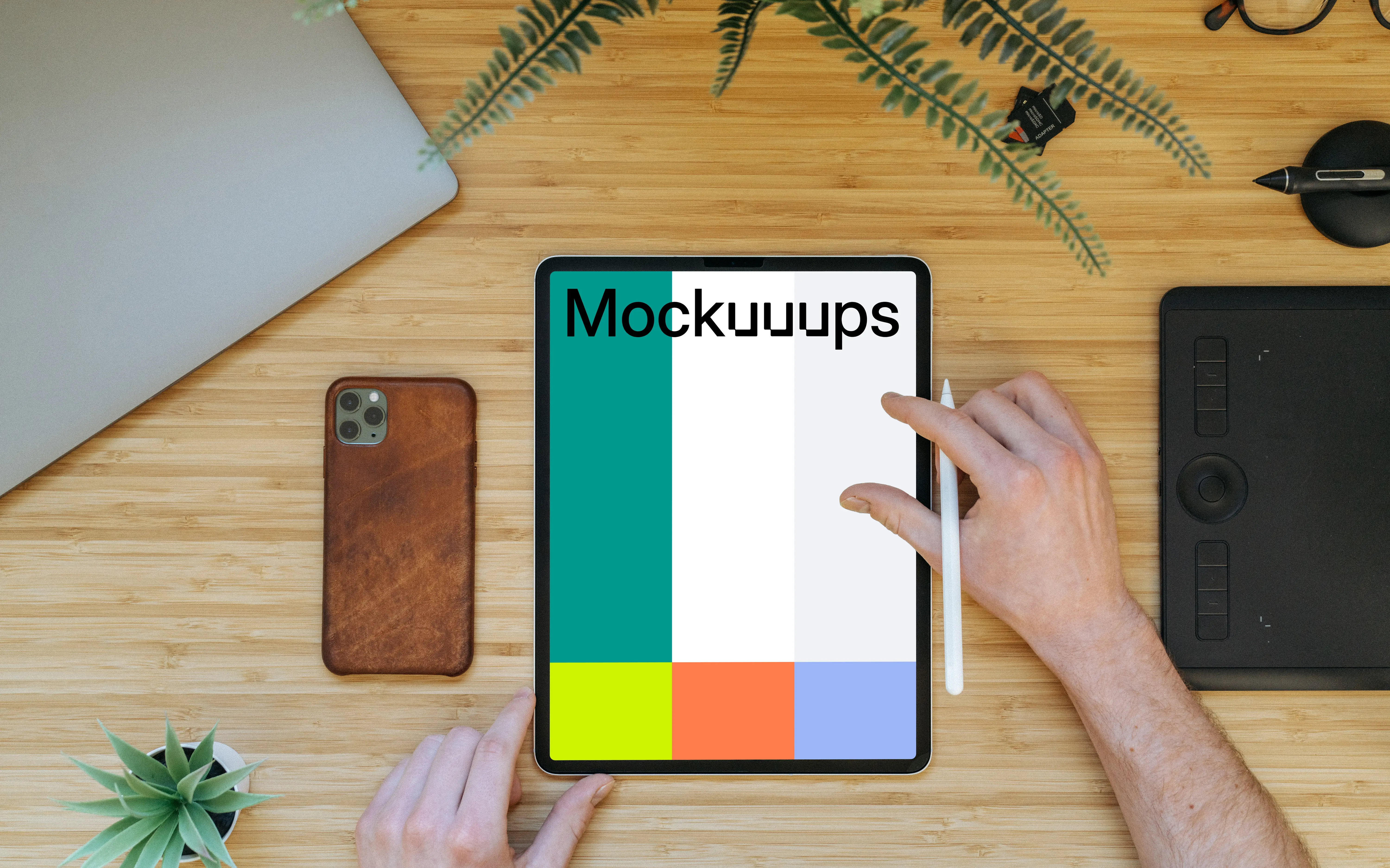 Tablet mockup on a wooden table with iPhone 11 at the side