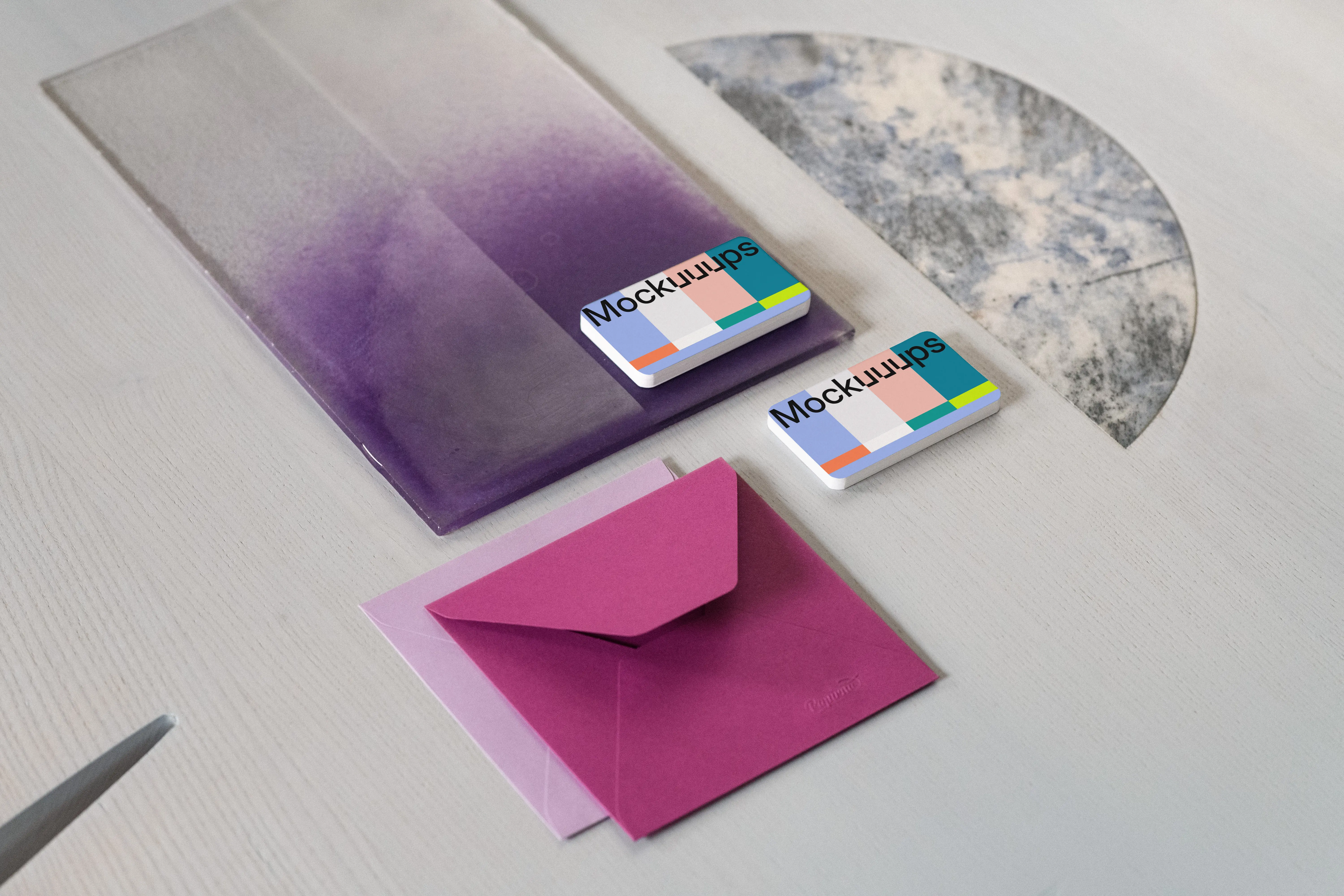 Two business cards mockup with colorful envelopes on textured surface